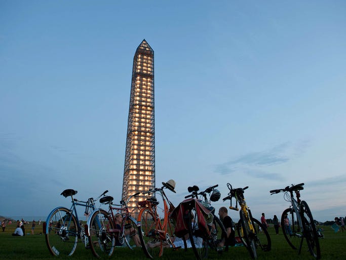 The Washington Monument, surrounded by scaffolding, is lit up as it undergoes repairs in Washington on July 8, 2013. The monument suffered damage during a 5.8-magnitude earthquake on Aug. 23, 2011.