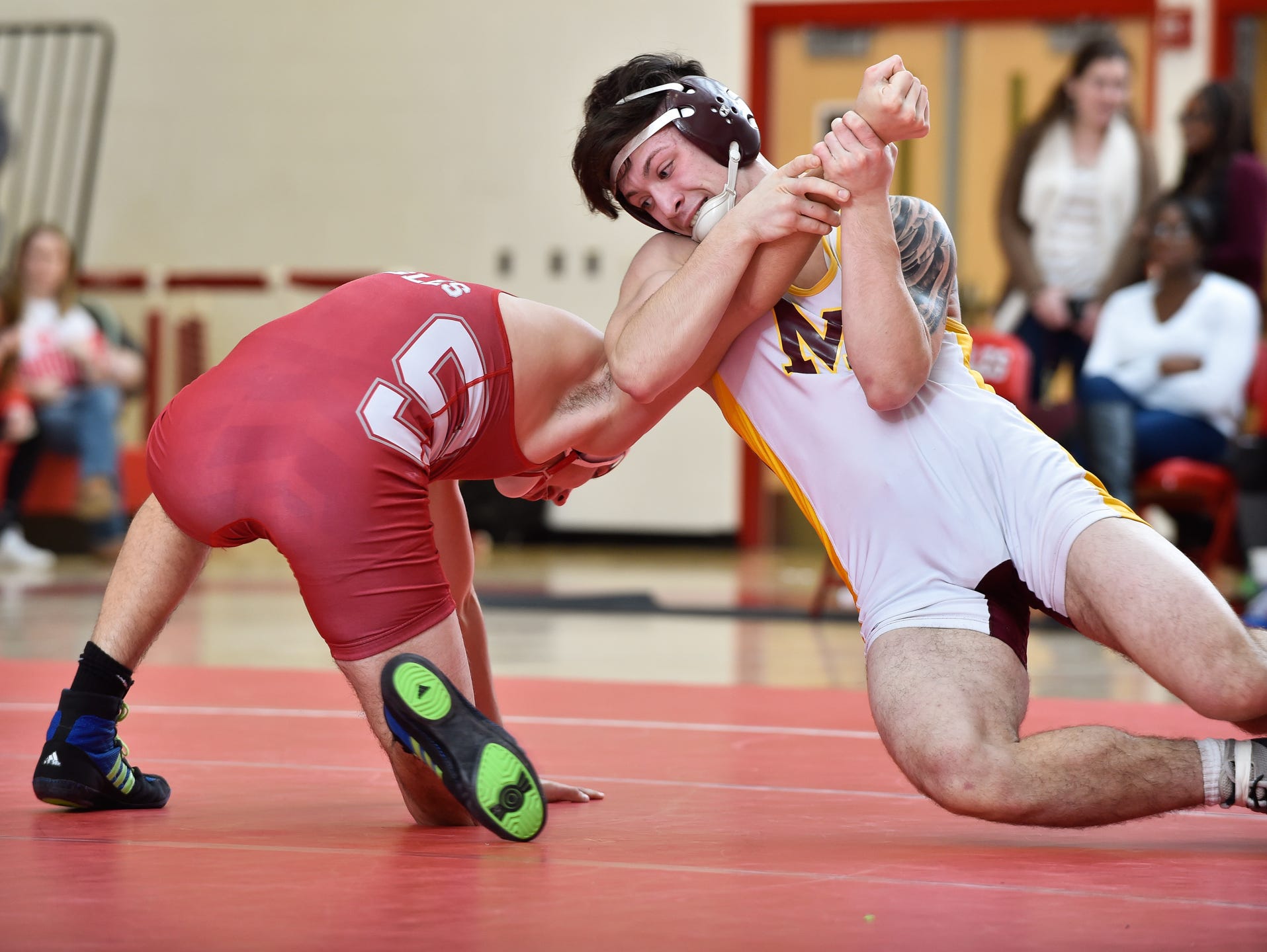 Milford's Chase Taylor, right grabs the arm of Smyrna's Dakota Kerr in the 152 pound match at Smyrna High School.