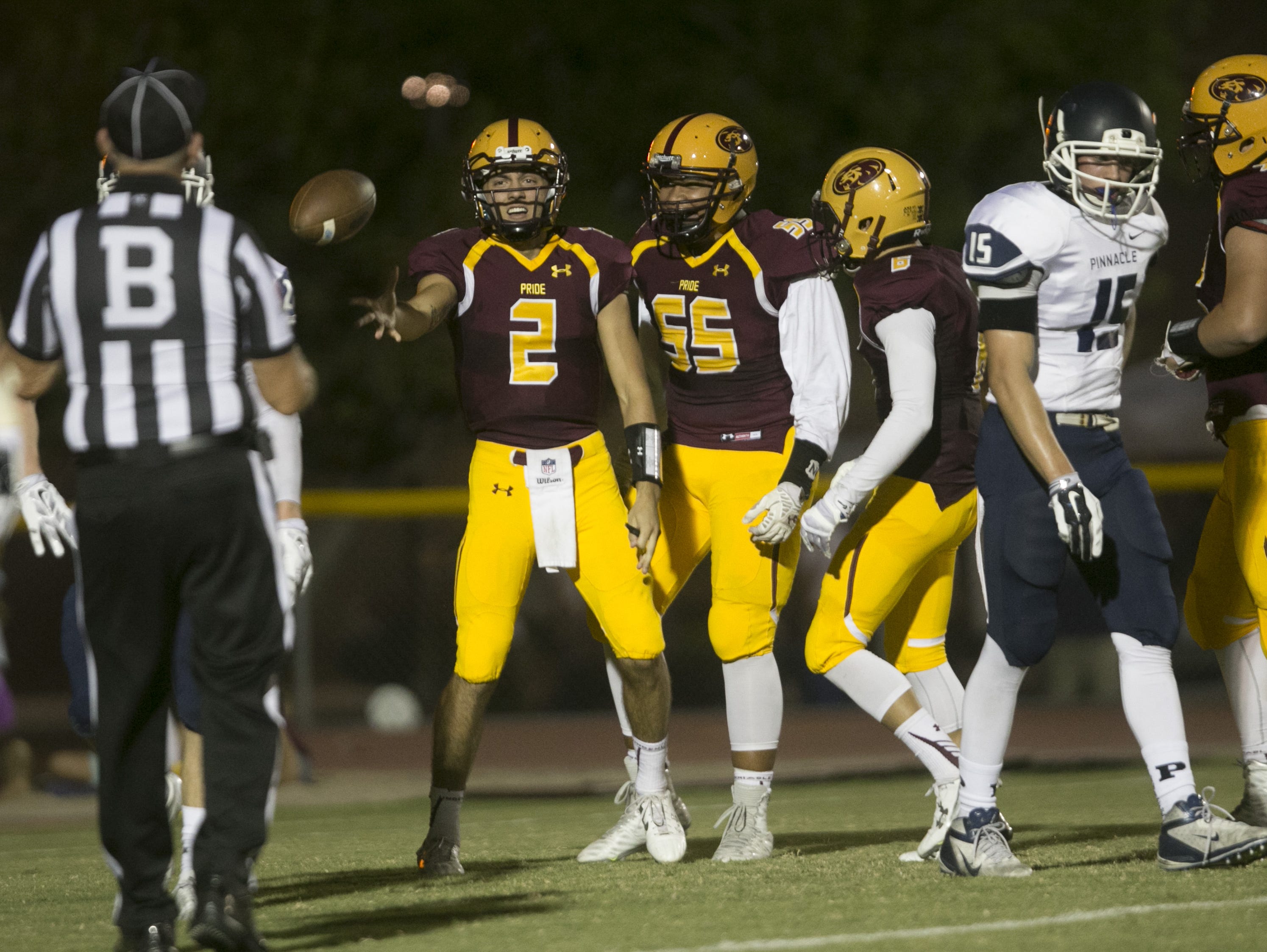 Mountain Pointe's Jack Smith tosses the ball to the referee after scoring a running TD against Pinnacle at Mountain Pointe High School in Phoenix, AZ on September 25, 2015.