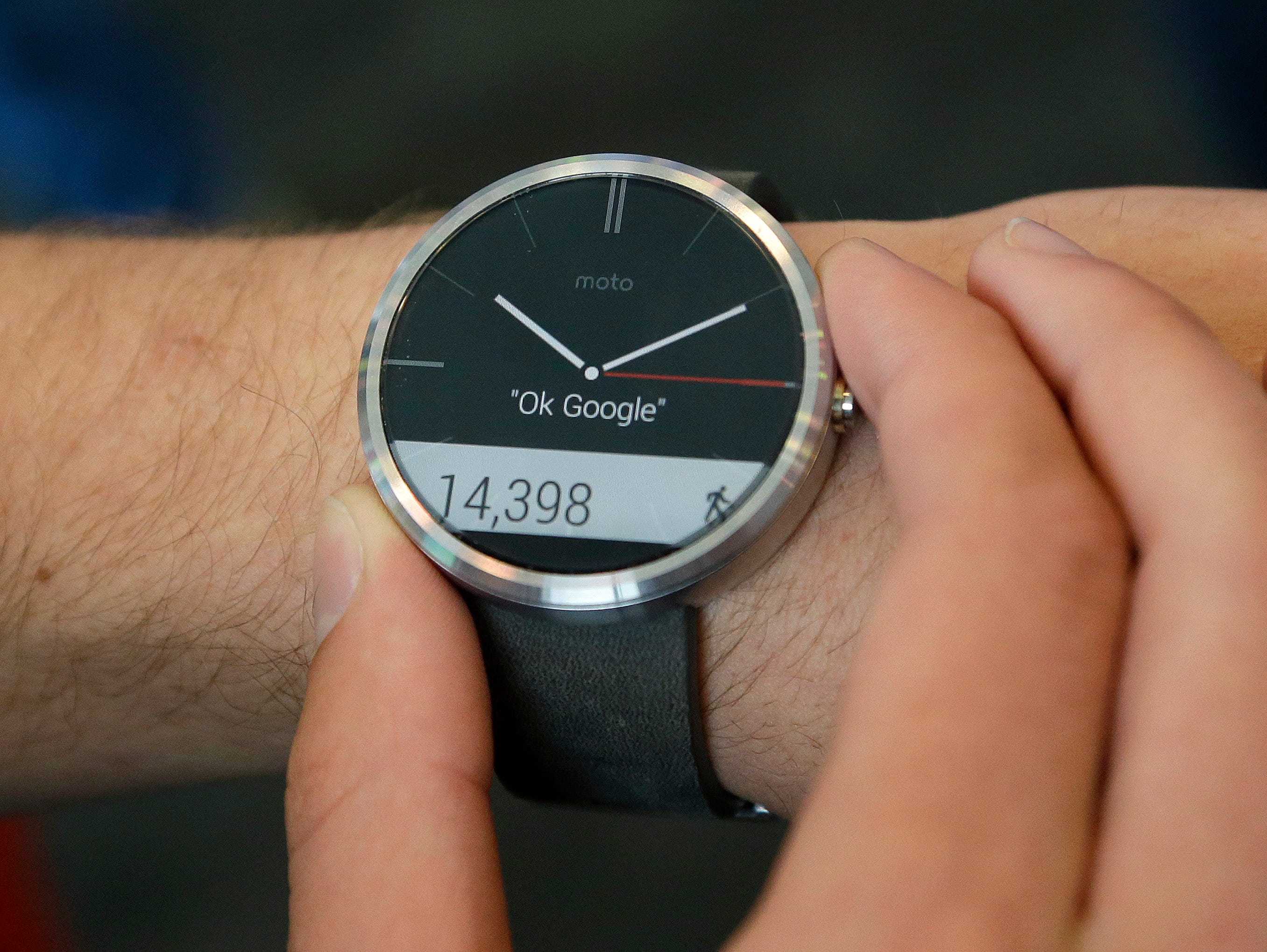A man wears a Moto 360 by Motorola, an Android Wear smartwatch, on the demo floor at Google I/O 2014 in San Francisco on June 25, 2014.
