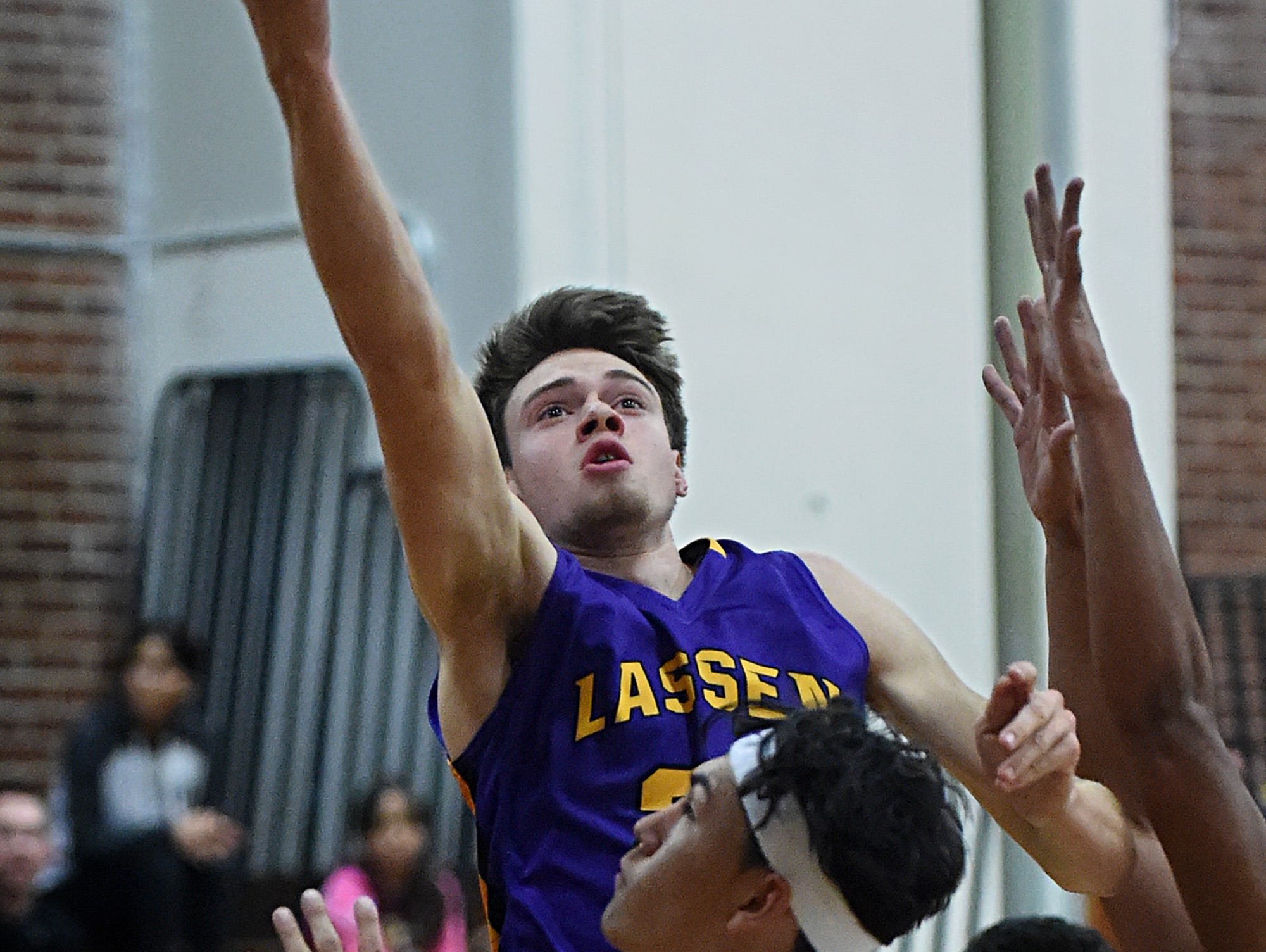 Lassen's Wyatt Martin goes up to score against Sparks during Tuesday's game at Sparks.