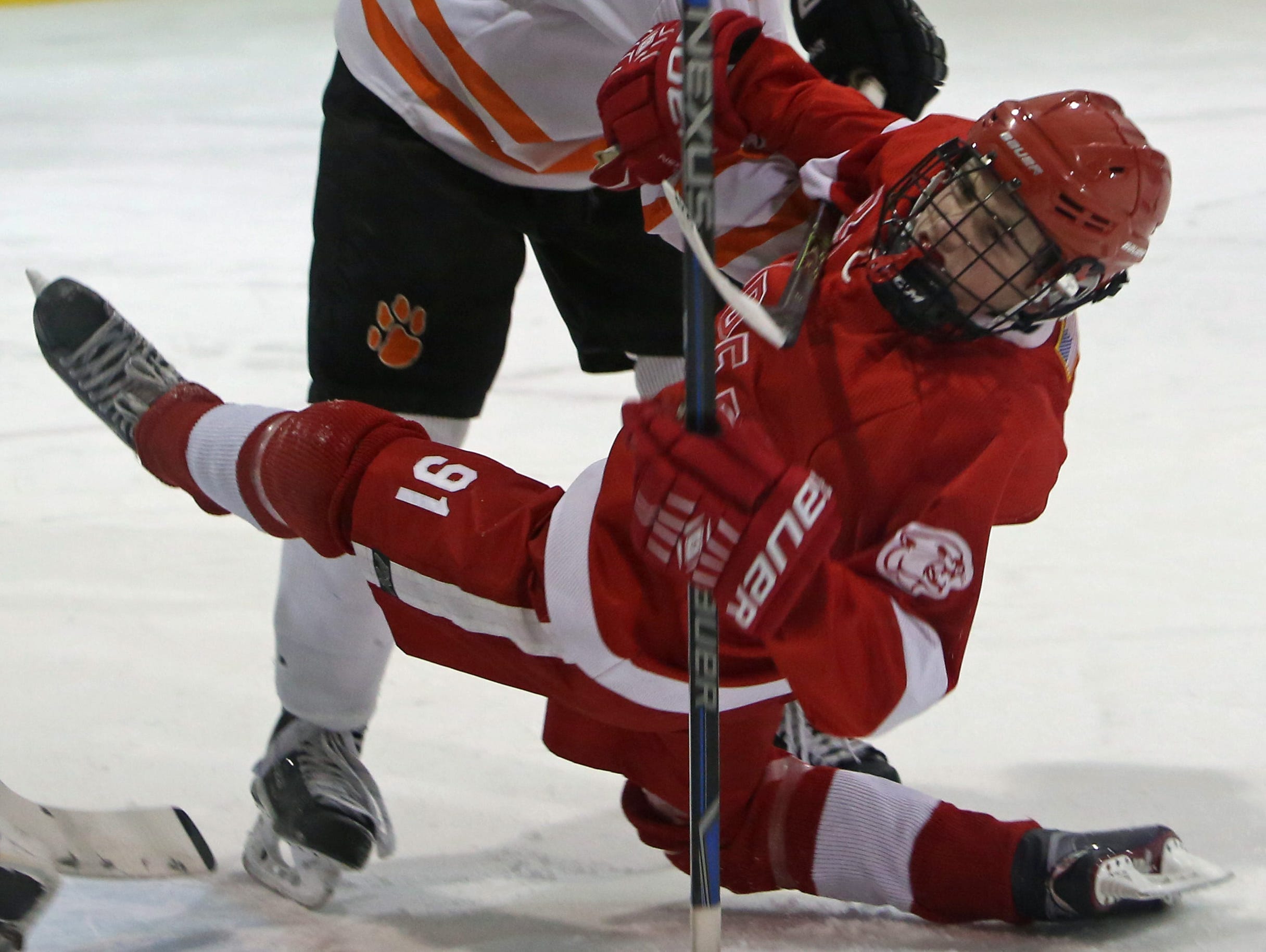 From left, White Plains' James Garnett (2) hits North Rockland's Christopher Hilliard (91) during hockey action at Ebersole Ice Rink in White Plains Jan. 7, 2016. The game ended in a 4-4 tie.