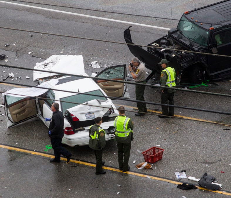 Los Angeles County Sheriff's deputies investigate the scene of a car crash where one person was killed and at least seven others were injured Feb. 7, 2015.