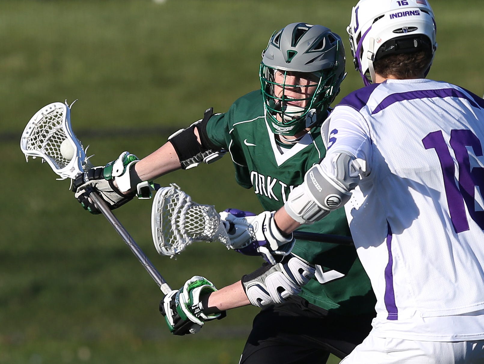 Yorktown's Kyle Casey (15) tries to get around John Jay's William Slater (16) during a boys lacrosse game at John Jay High School in Cross River April 14, 2016. Yorktown won the game 9-7.