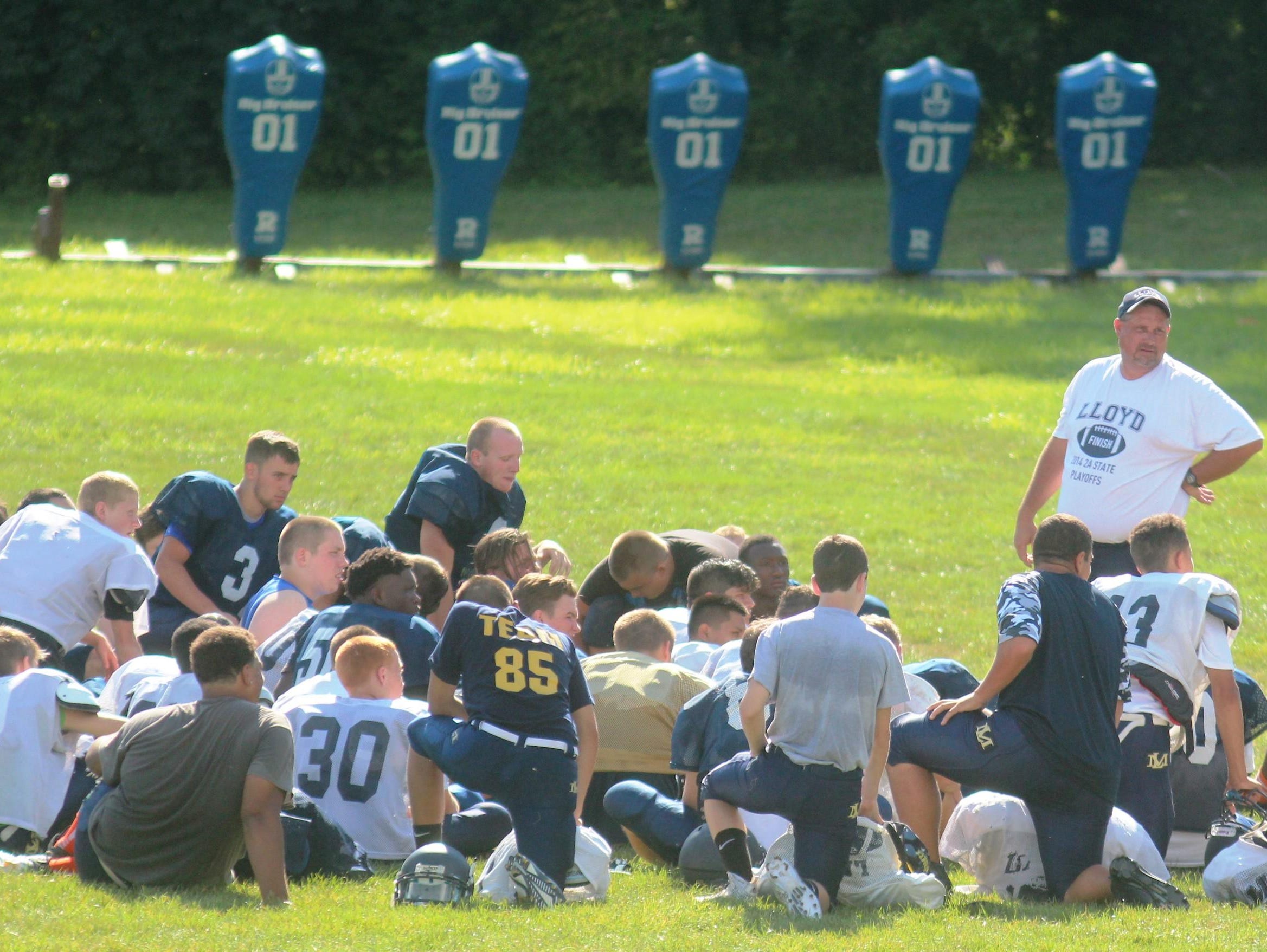 Lloyd coach Eric Turner addresses the team after practice.