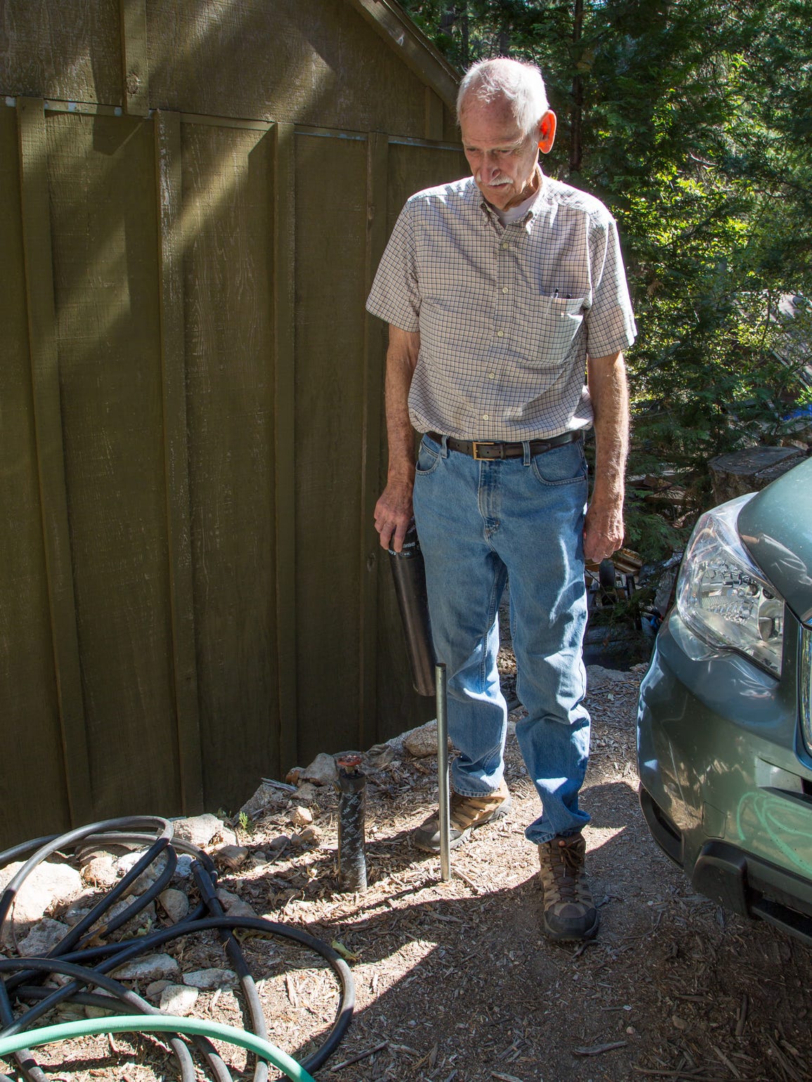 Don Bailey examines one of the water valves outside