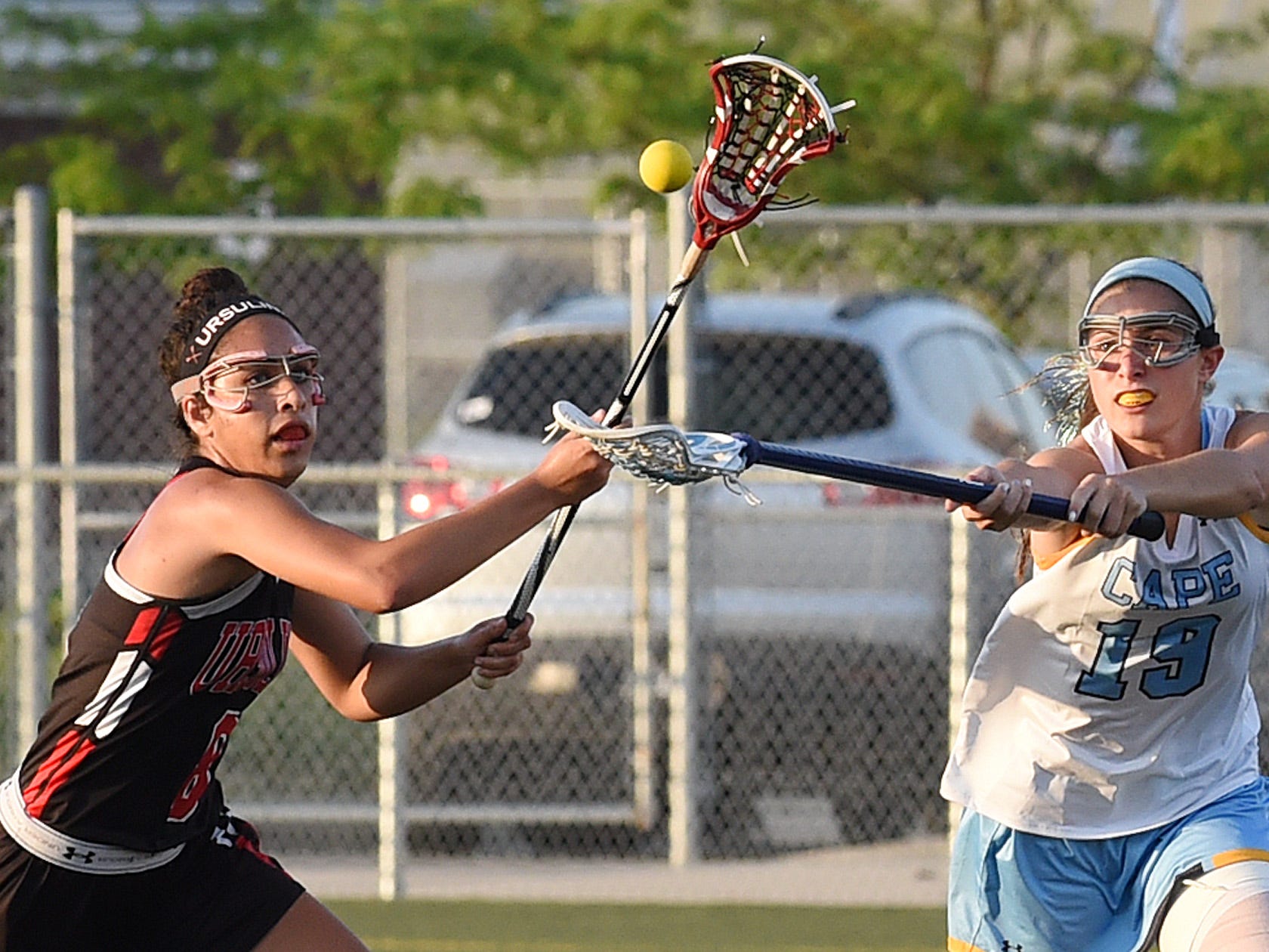 Cape Henlopen’s Alison Palmer and Ursuline’s Emily Blaszkow go after the ball in Cape’s 17-4 win on Tuesday.