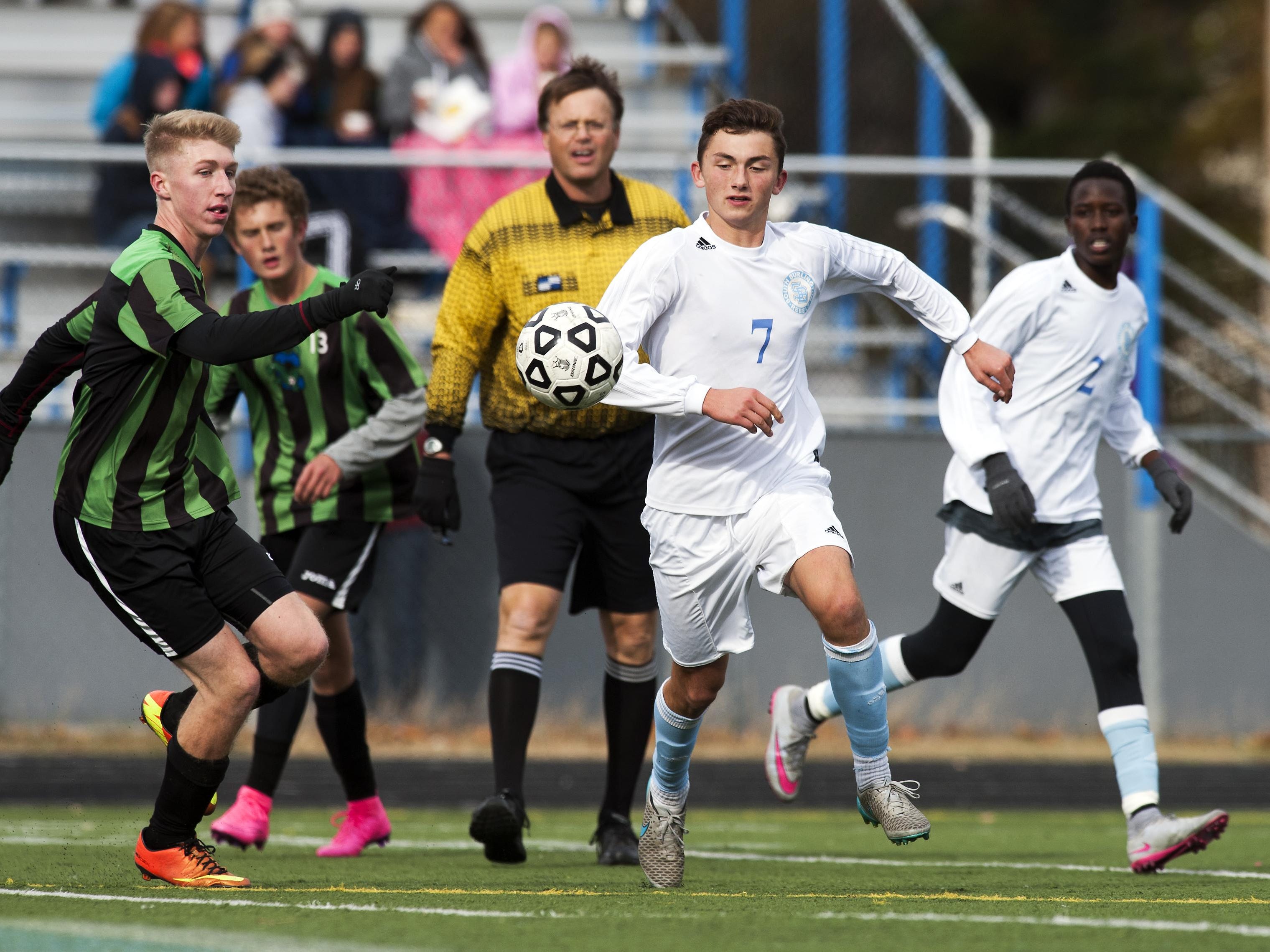 South Burlington’s Ben Lambert (7) and Colchester’s Amdrew Lynch (9) chase down the ball during a Division I high school boys soccer quarterfinal game at South Burlington on Saturday. The Rebels won 1-0 to advance to Tuesday’s semifinals.