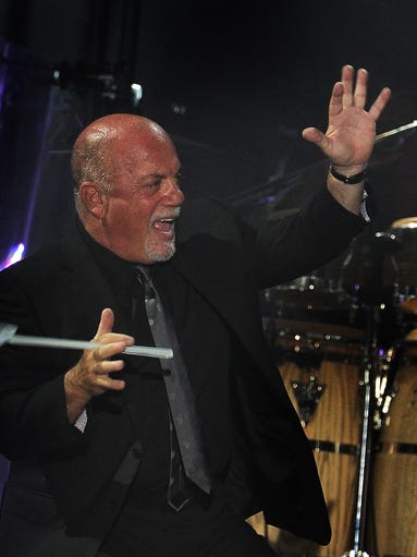 Billy Joel waves to the crowd as before he performed