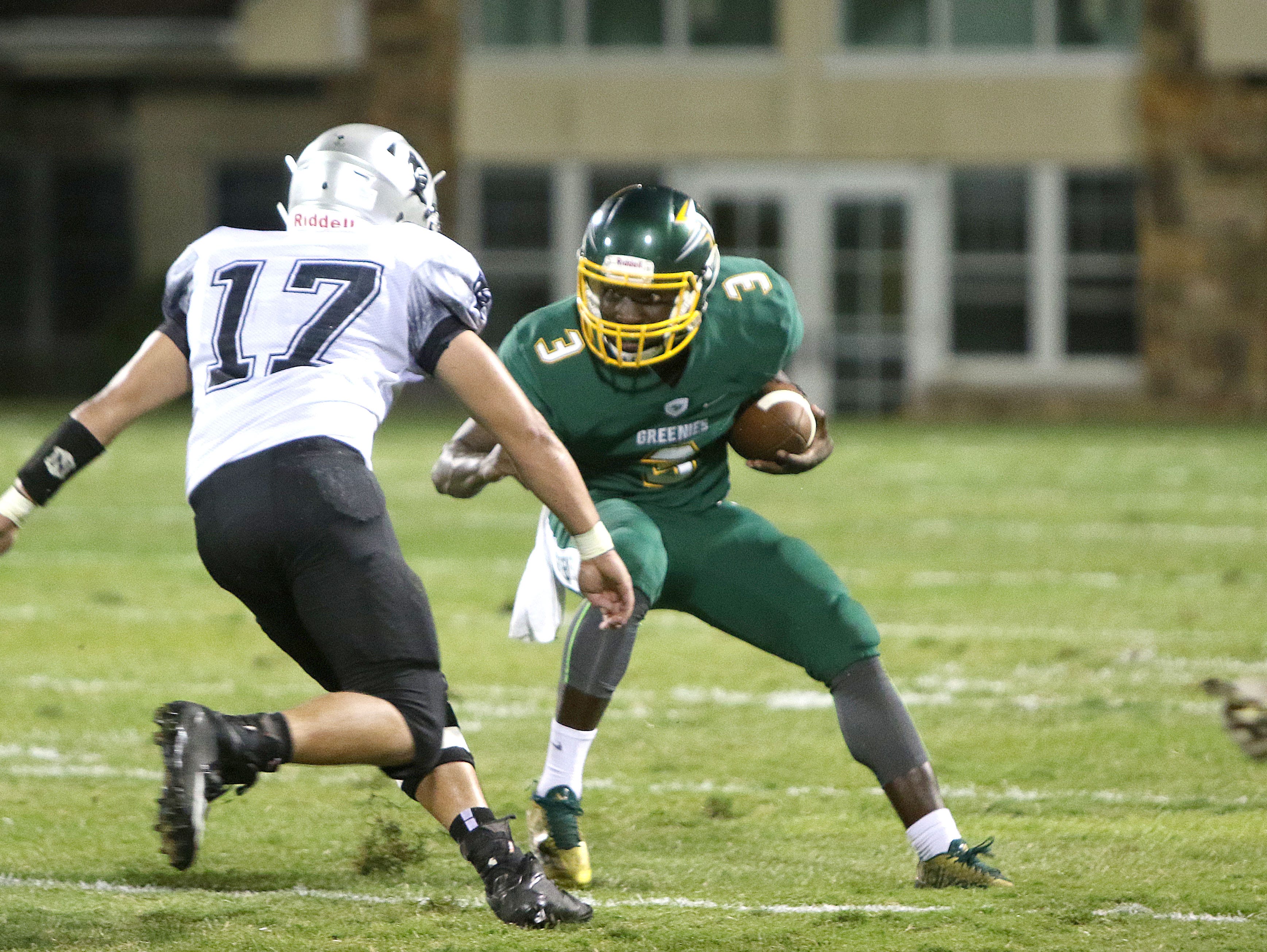 Christ School's Kokayi Cobb (3) looks to evade a tackle from Robbinsville's A.J. Ornelas on Thursday night in Arden.