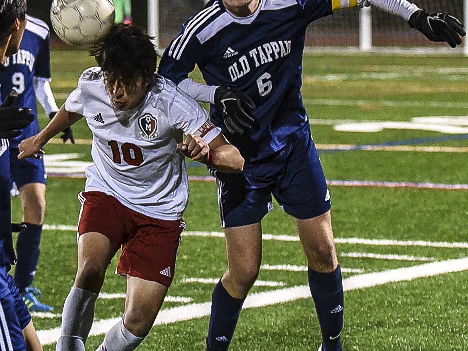 Mendham's Christian Perercini (10) heads the ball away from Old Tappan's Kevin Loudon (6) in the NJSIAA Group III Semifinal at Ridge High School in Basking Ridge, November 17, 2015. Photo by Warren Wetura for the Daily Record.
