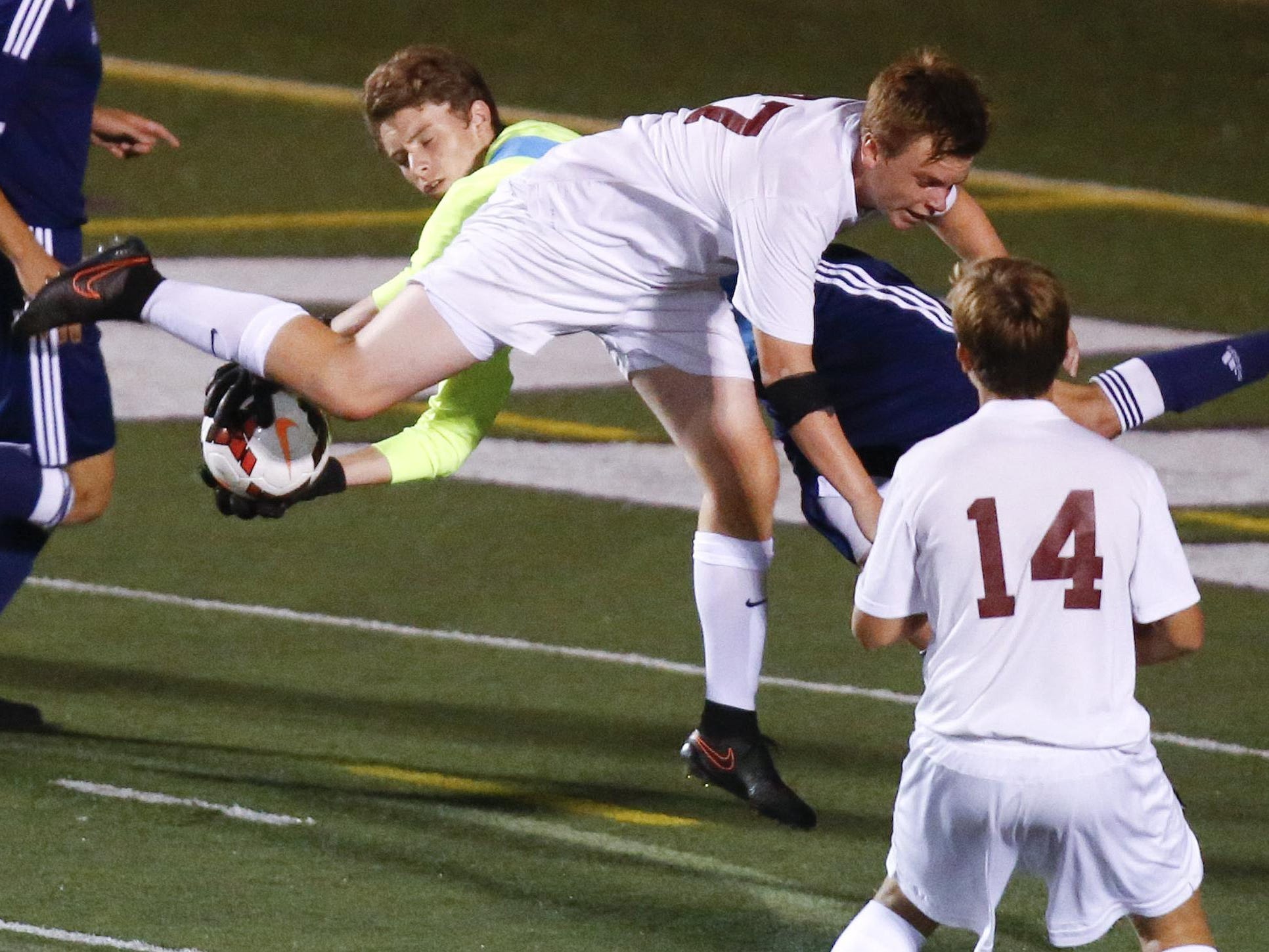 Caravel’s Lucas Partlow collides with Salesianum goalkeeper Gavin Campbell in the first half of Salesianum’s 3-0 win at Caravel Tuesday.