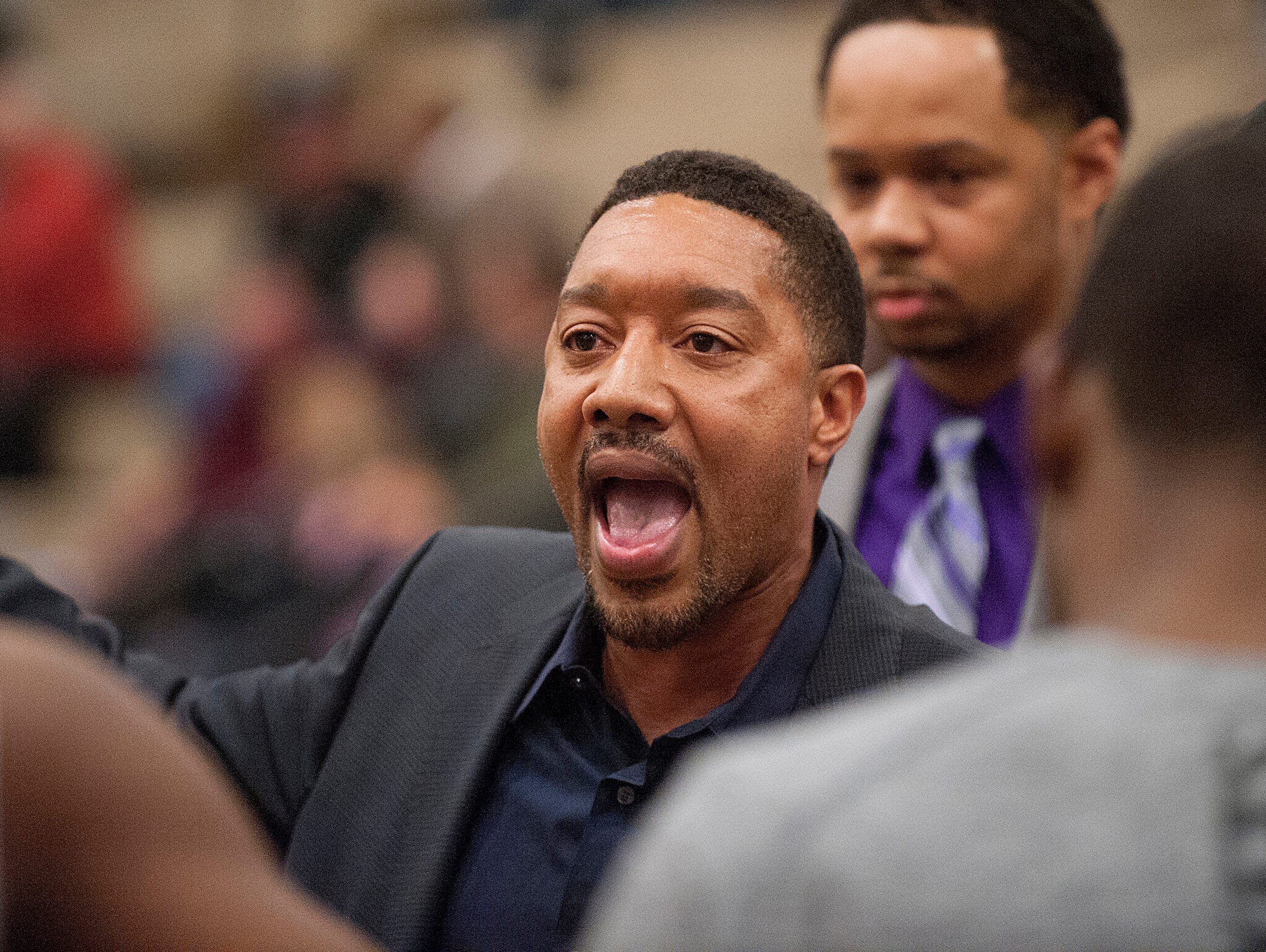 Central Yellow Jackets head basketball coach Douglas Bibby talks to his players during a time-out. 10 February 2015