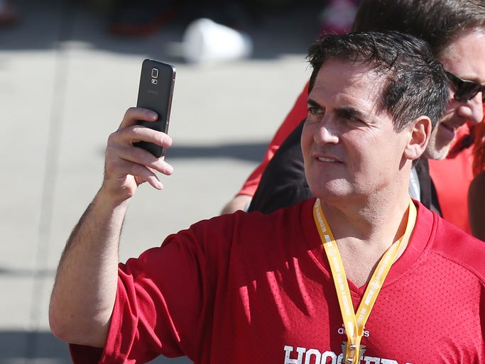 Businessman Mark Cuban takes in the scene on the red