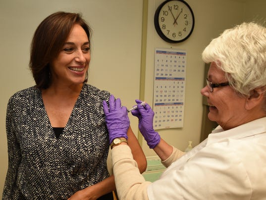 Dr. Karen DeSalvo receiving her flu shot.