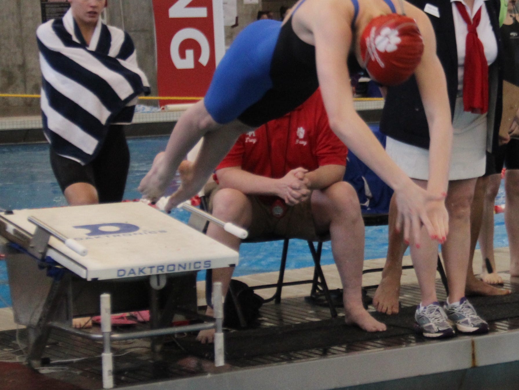 Mollie Bushelman takes off in the medley relay during the KHSAA girls state swimming and diving meet March 1, 2014 at the University of Louisville.