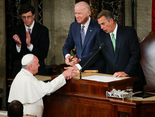 Pope Francis is greeted by House Speaker John Boehner