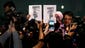 Members of the media photograph pictures two men who boarded the missing Malaysia Airlines jet with stolen passports during a press conference in Sepang.