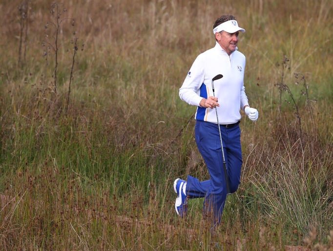 Europe's Ian Poulter runs to the fourth tee.