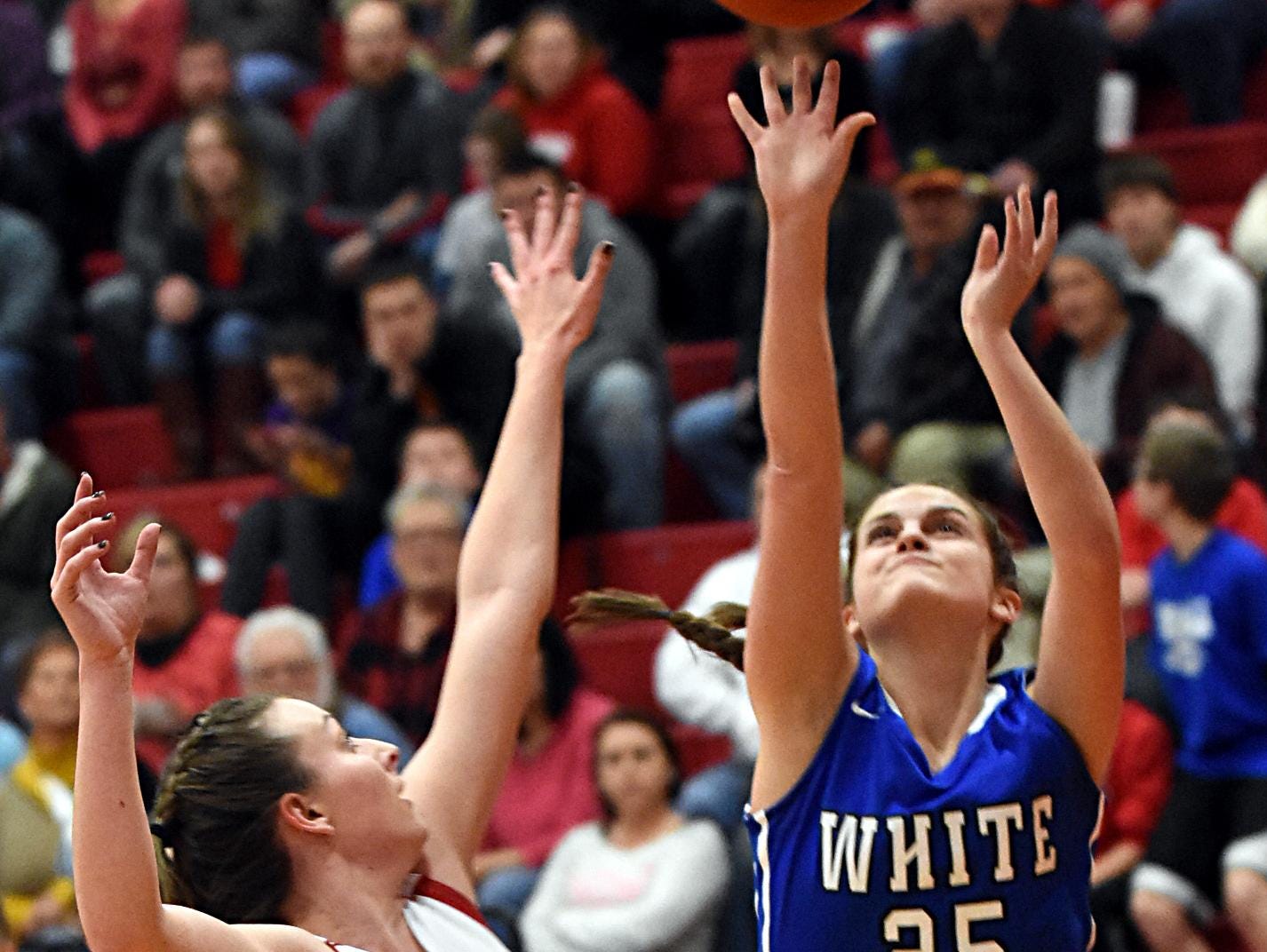 White House High junior forward Bailey Hutchison releases an interior shot in front of Westmoreland senior Haley Braswell during second-quarter action.