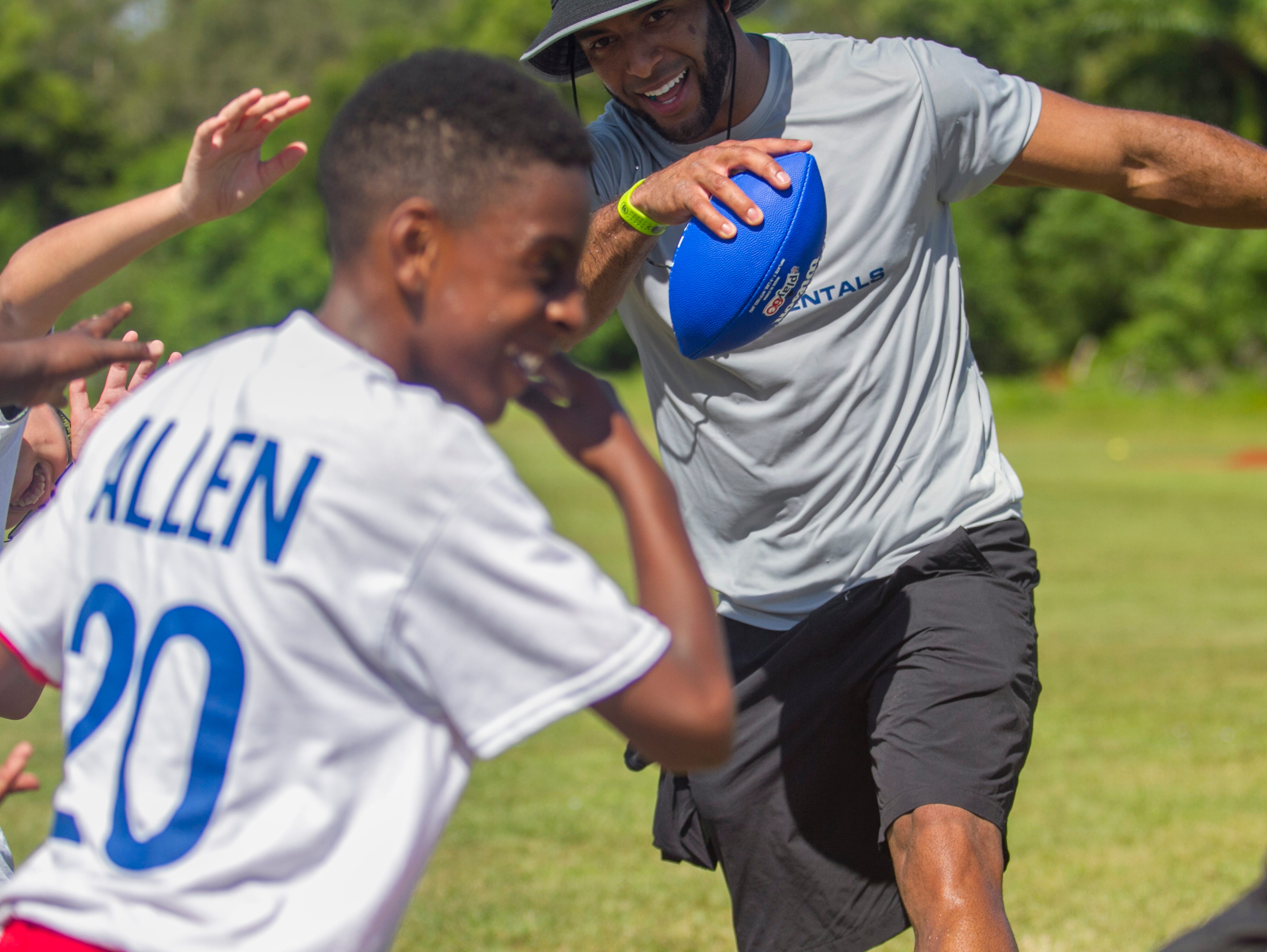 Nate Allen dabs with a group during his free youth football camp at McGregor Baptist Church on Saturday in Fort Myers.