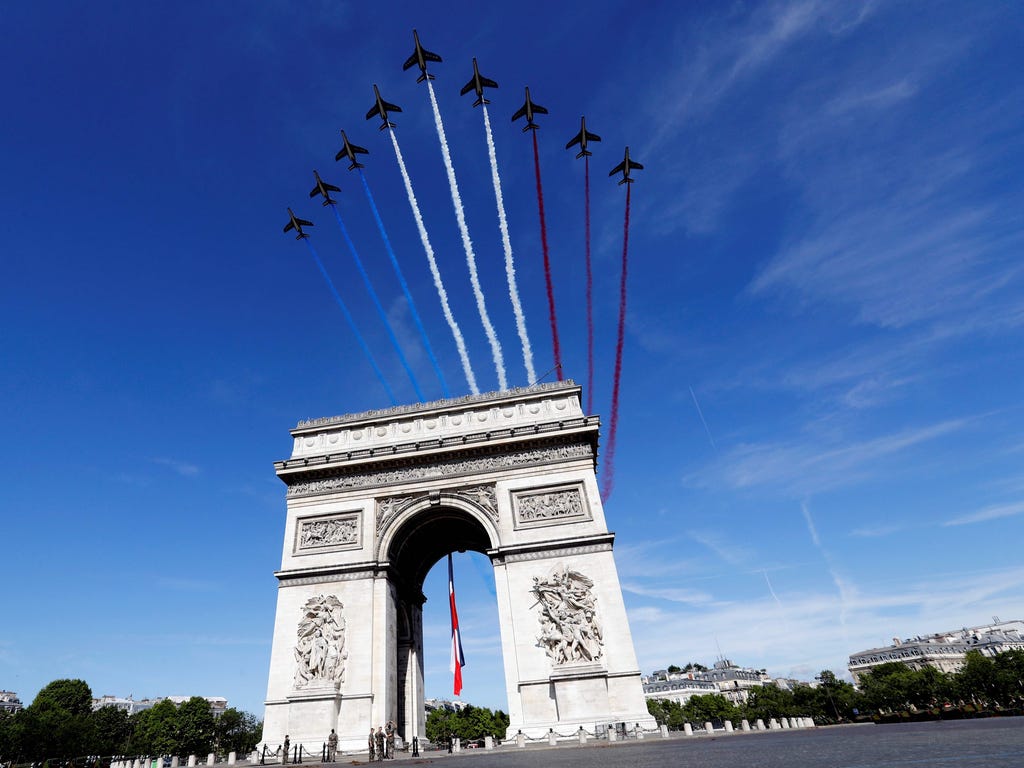 French AlphaJet of the Patrouille de France fly over The Arc de Triomphe on the Champs Elysees Avenue in Paris on July 14, 2017, during the Bastille Day military parade.\u000d\u000aBastille Day, the French National Day, is held annually each July 14,