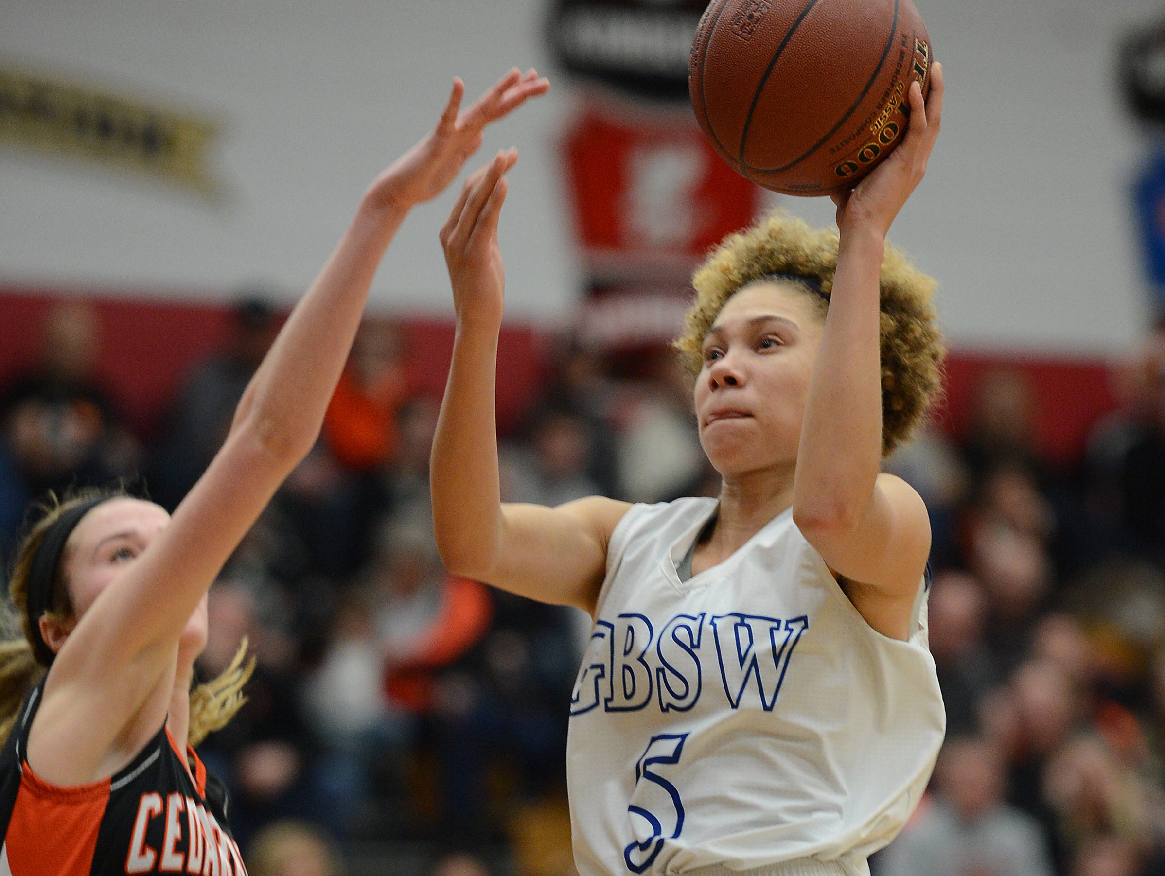 Green Bay Southwest HIgh School player Natisha Hiedeman (5) drives the lane in the D2 sectional finals against Cedarburg at Fond du Lac.