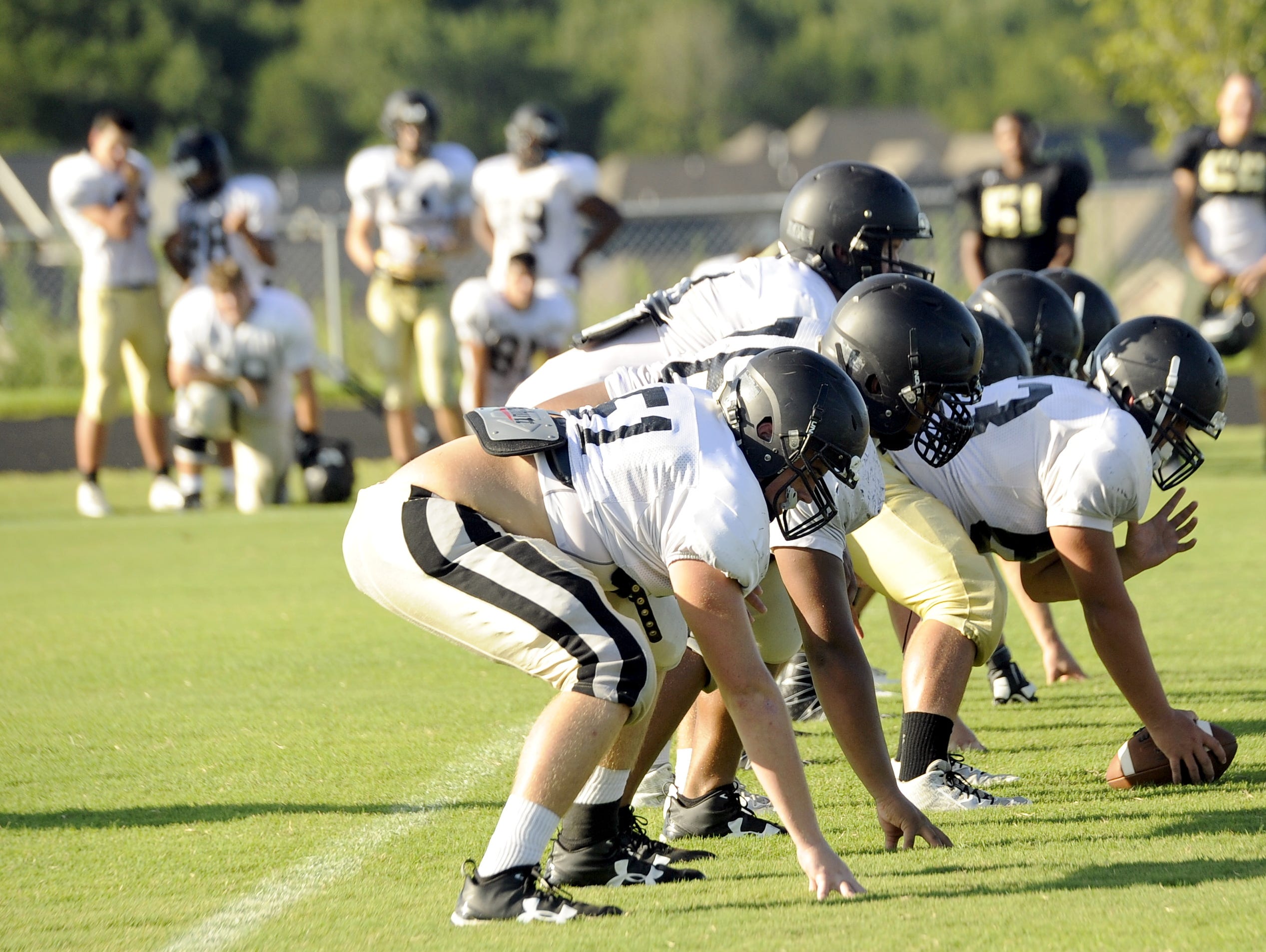 The Mt. Juliet offense runs through plays during a recent practice.