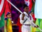 Simone Biles carries the American flag during the closing