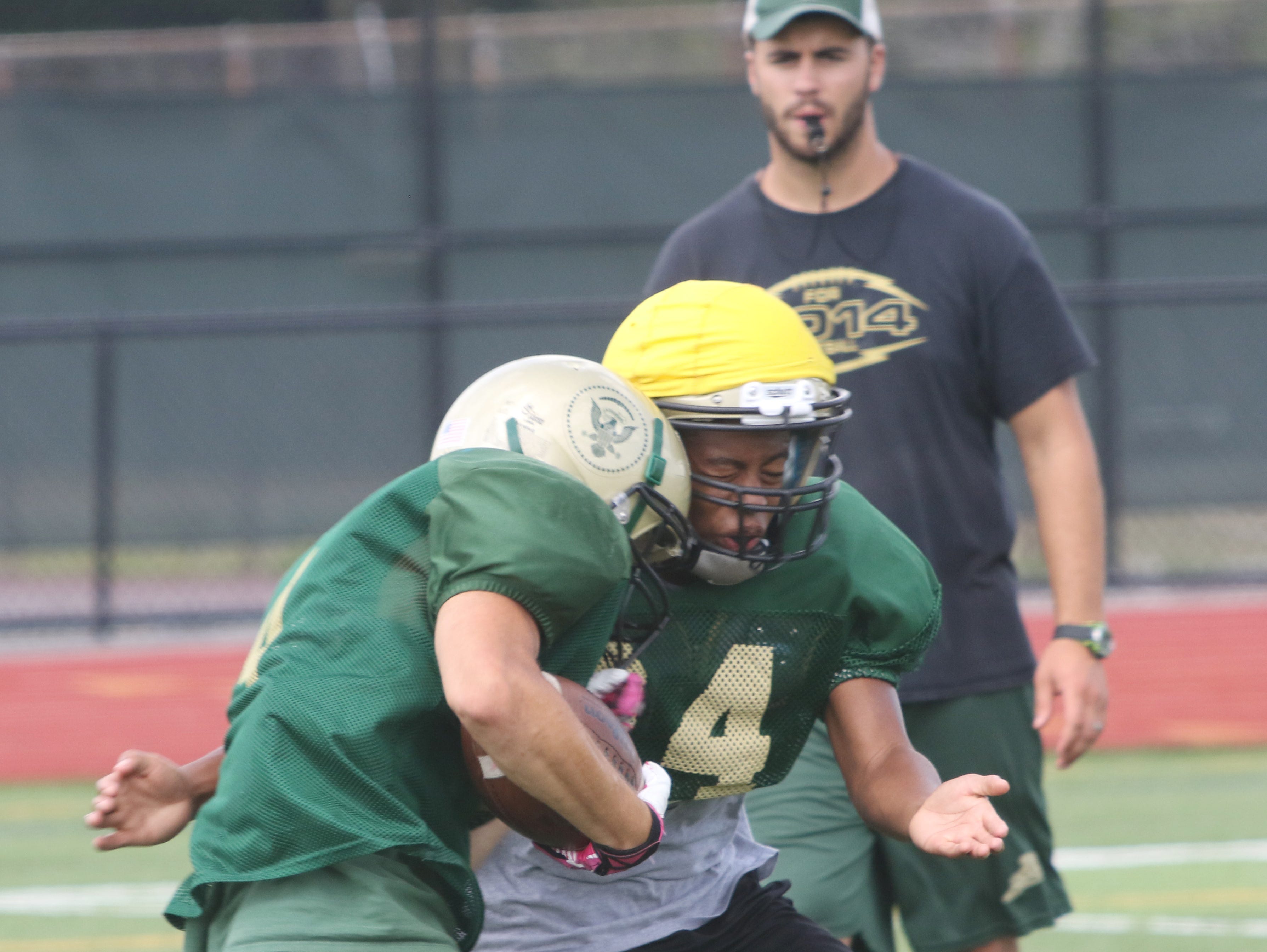 A pair of Franklin D. Roosevelt High School football players collide during a preseason practice on Aug. 20.