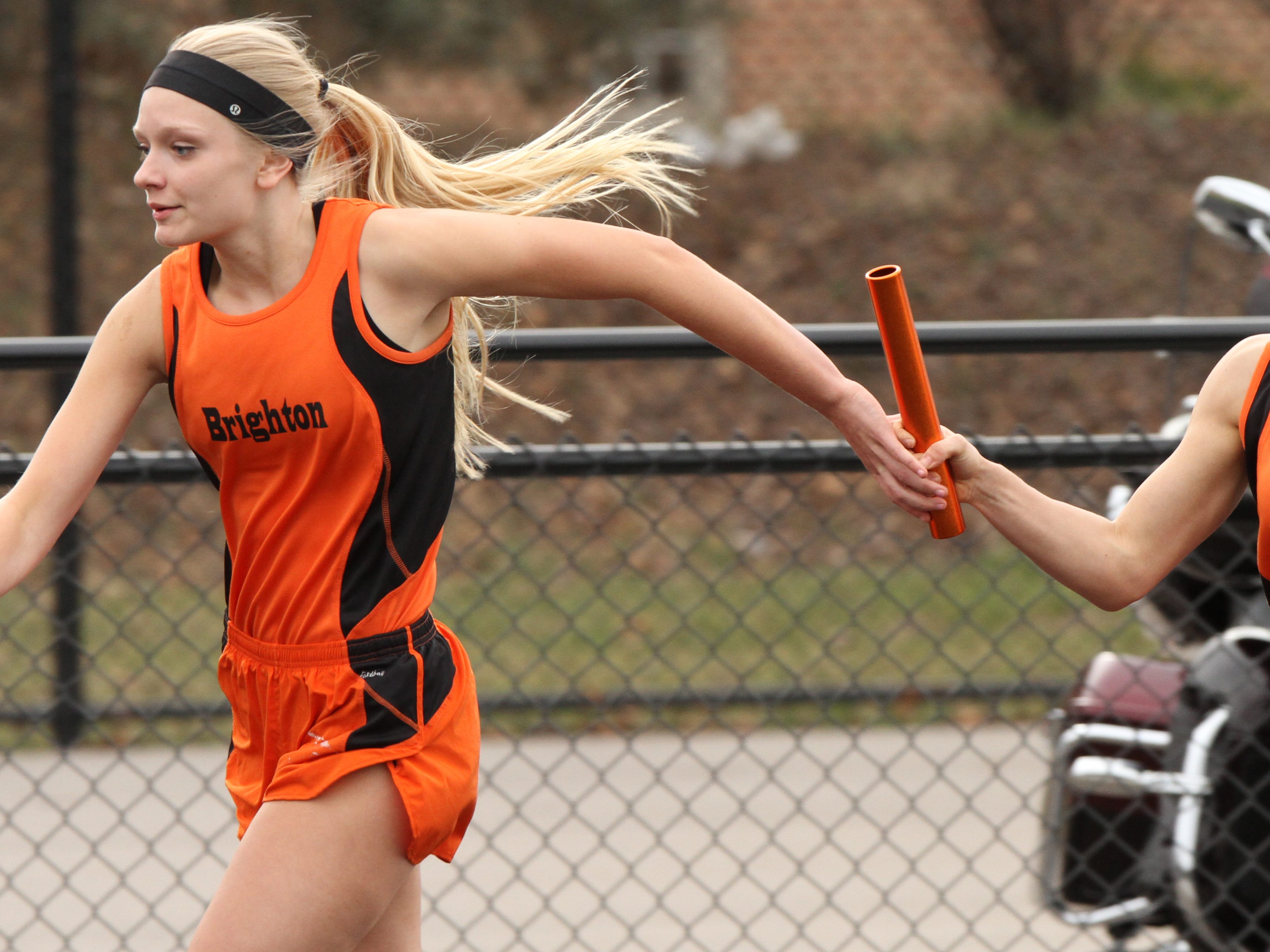 Brighton's Brooke Harrity places the baton in the hands of of team mate Shannon McGrath in the 4x200 relay.