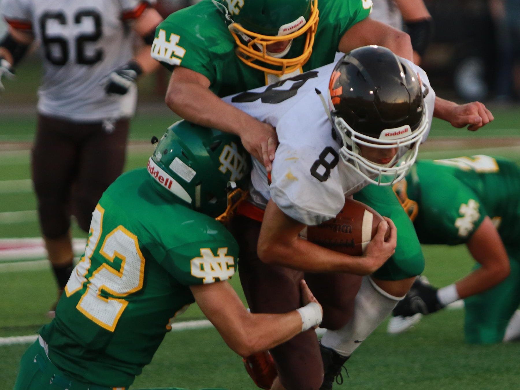 Jud Lewis and Sam Bending tackleHunter Edwards of Nelsonville-York in their first home game of the season.