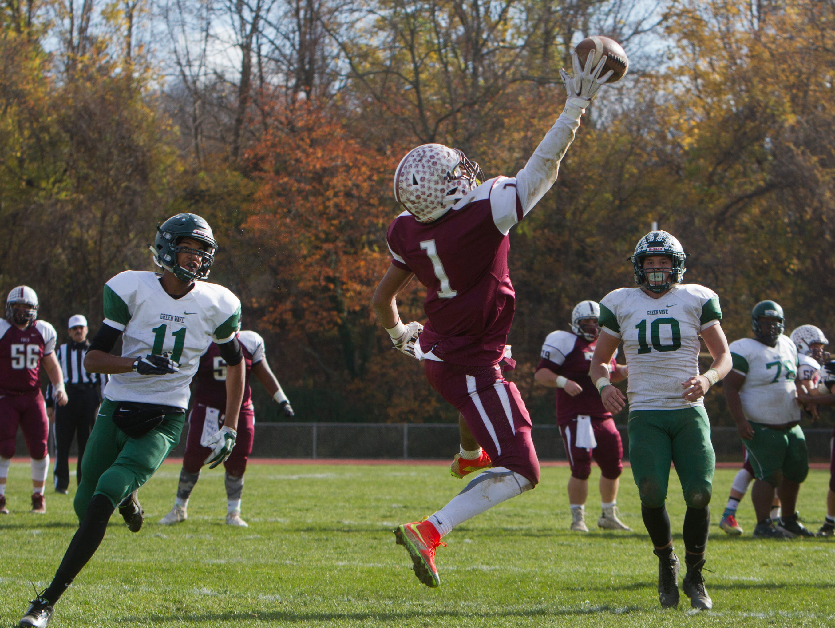 Red Bank Regional's Teddy Mitchell pulls down a pass over the middle and heads into endzone for his team's third touchdown of game. Long Branch vs Red Bank Regional Thanksgiving Day Football game in Red Bank NJ on November 26, 2015.