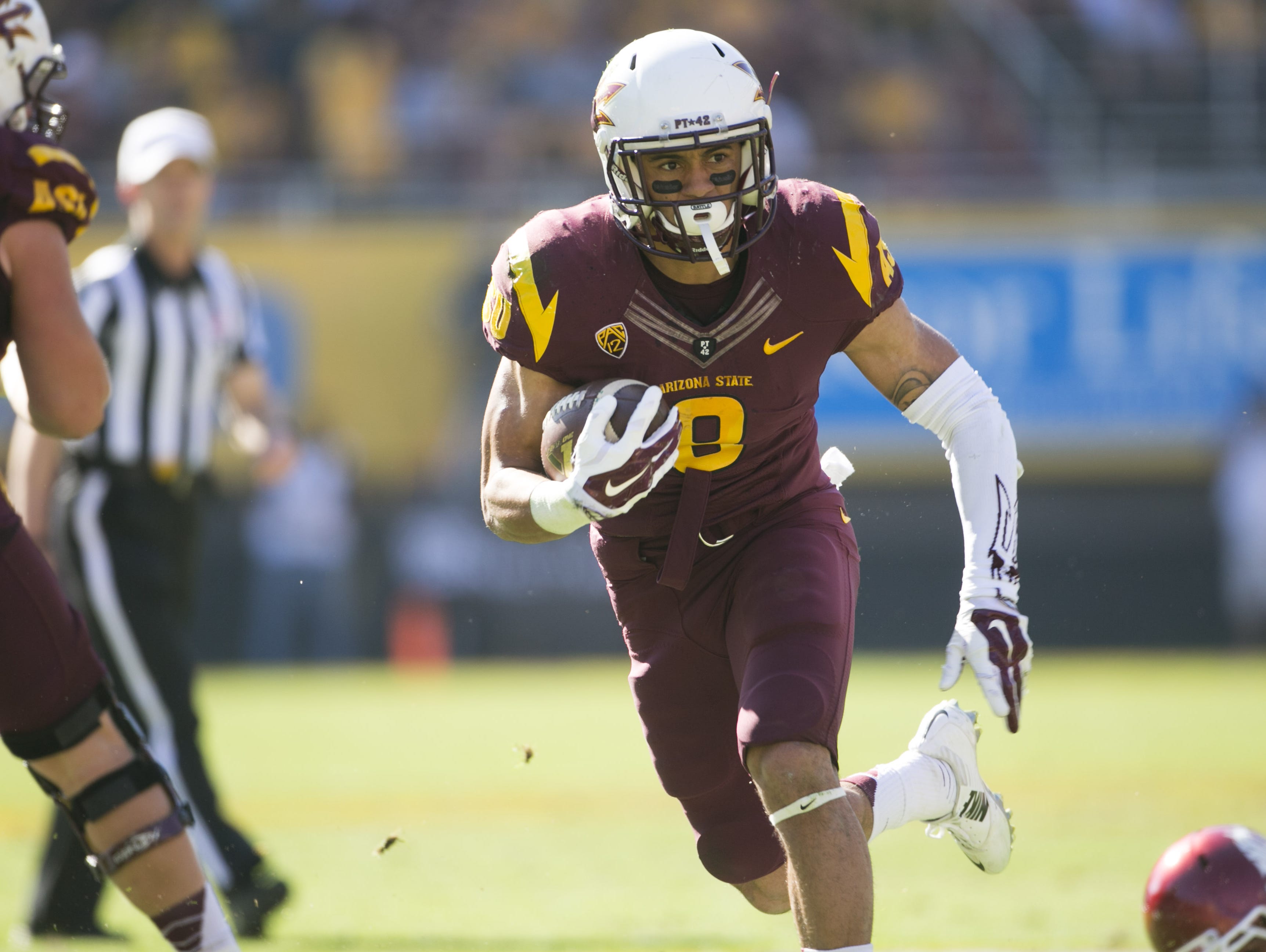 ASU running back D.J. Foster carries the ball for a touchdown against Washington State during the first half of the PAC-12 college football game at Sun Devil Stadium in Tempe on Saturday, November 22, 2014.