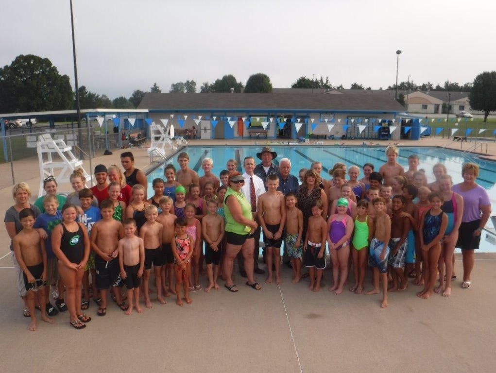 The Mountain Home Hurricane swim team was able to recently purchase eight brand new swim blocks for the city pool. Shown are Hurricane swimmers, coaches and board members with Mountain Home Mayor Joe Dillard at the city pool.