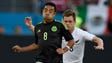 Mexico's Marco Fabian (8) moves the ball defended by