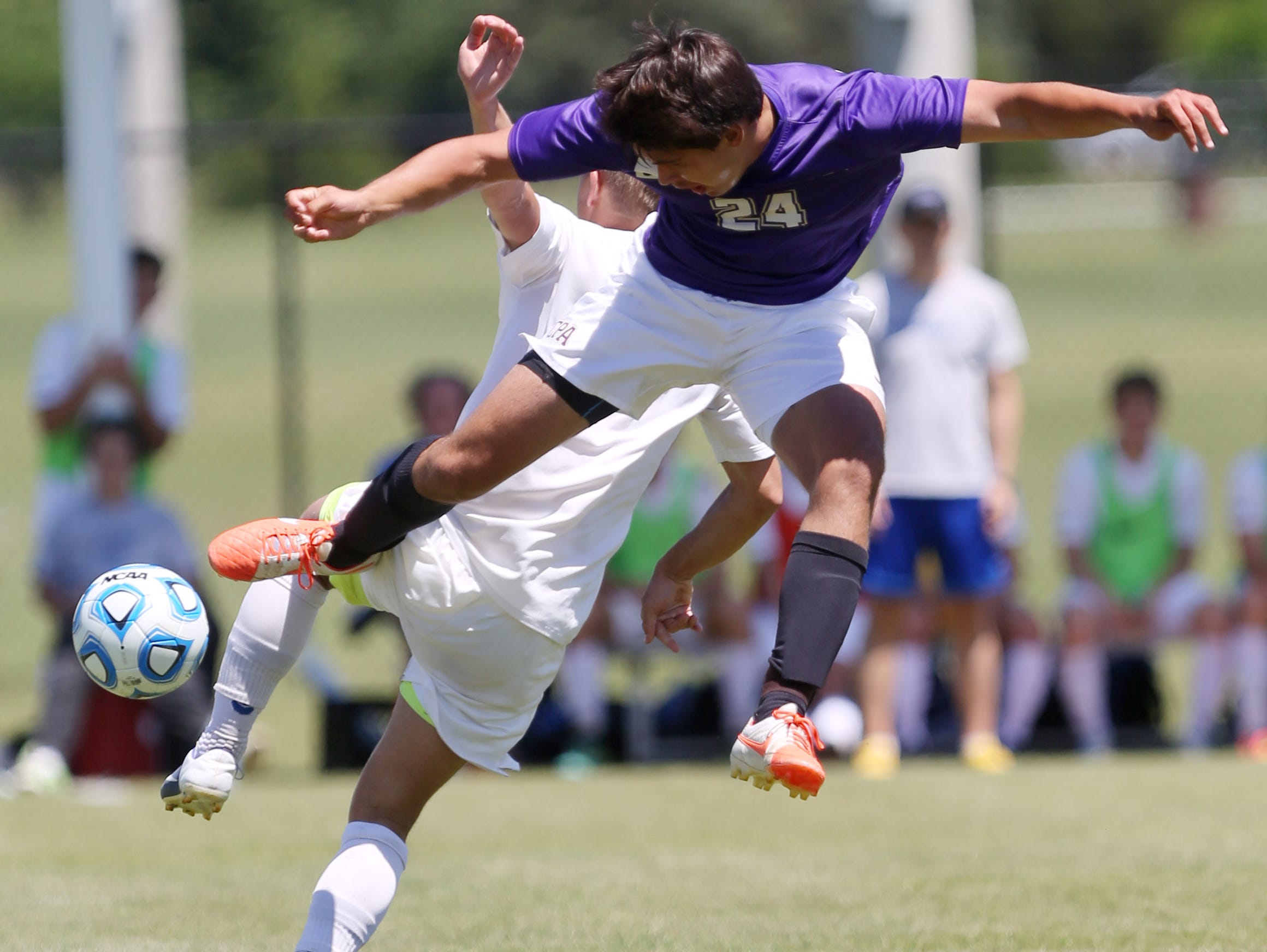 CPA's Spencer Hagan (24) lunges past Dallas Dunn (6) of CAK to get possession during the A-AA title match Friday.