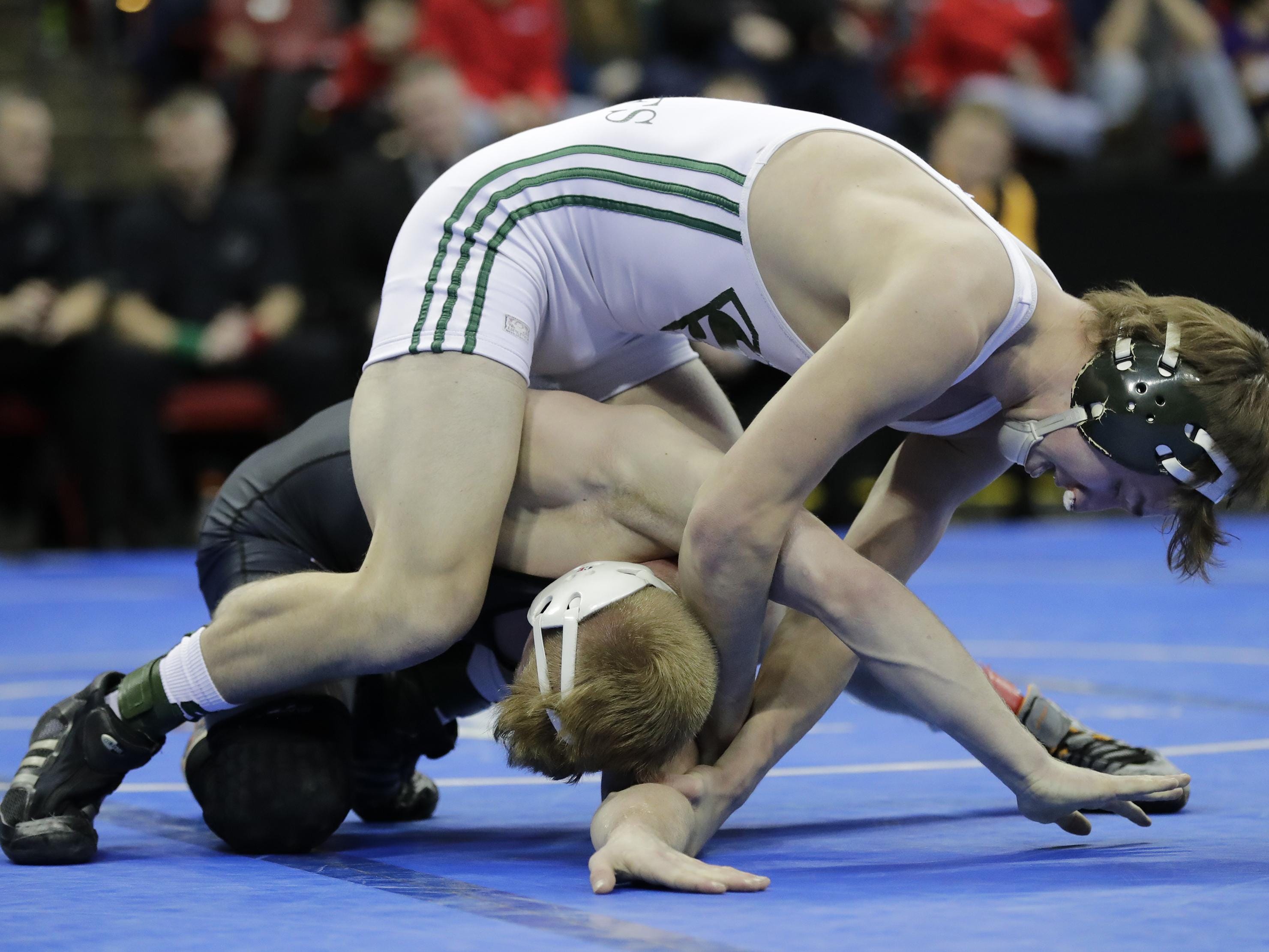 Shiocton’s Sammy VanStraten, top, wrestles against Stratford’s Jeremy Schoenherr in their 138-pound WIAA Division 3 championship match on Saturday during the 2017 Individual Wrestling State Tournament at the Kohl Center in Madison.