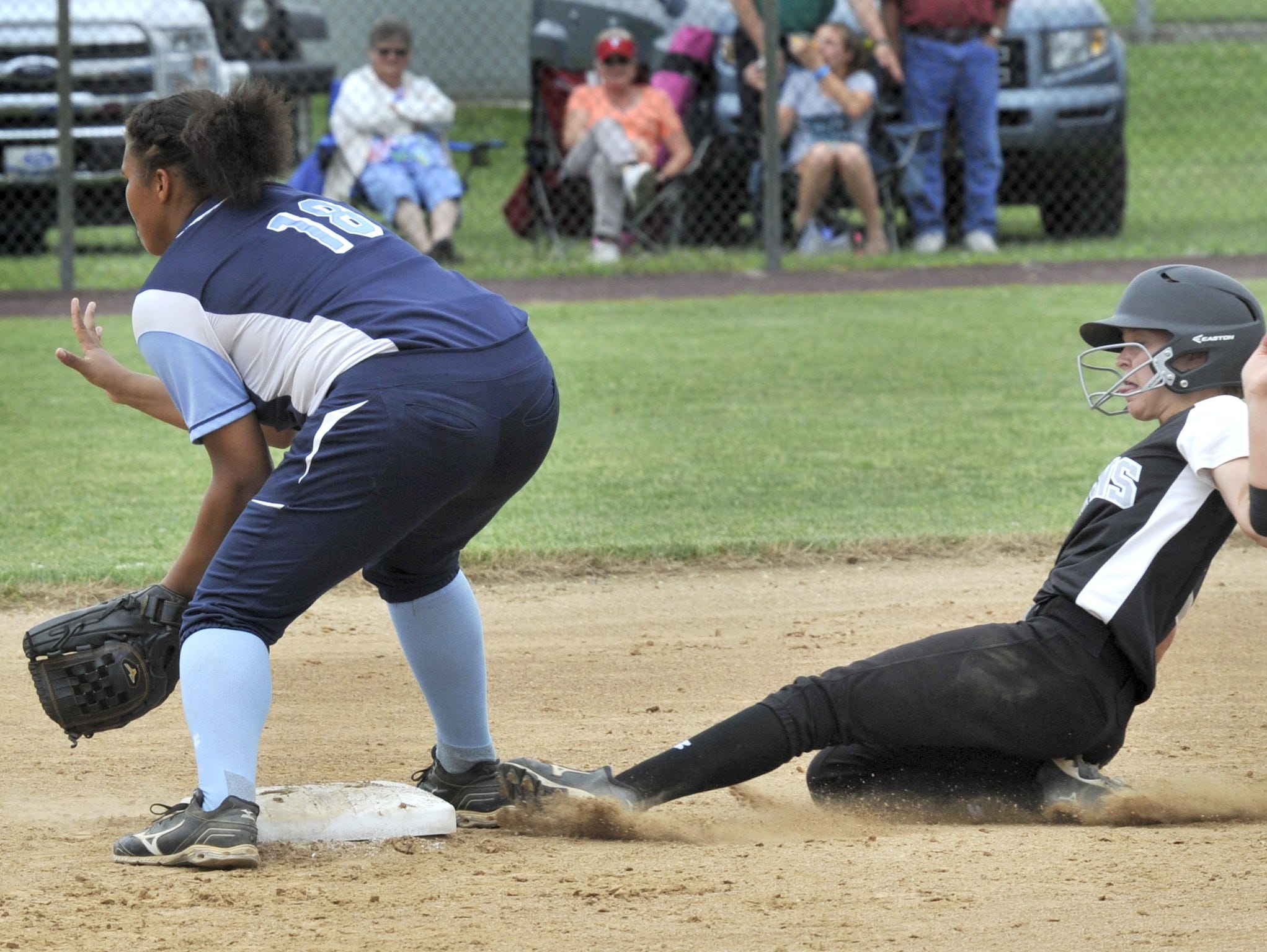 Nicole Hovatter of Sussex Tech slides into 2nd with a double in DIAA playoff game Thursday. Kayla Thompson of the Spartans takes the throw from the outfield.