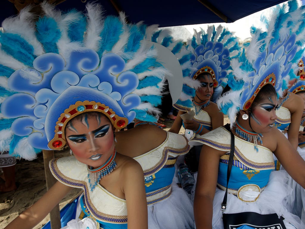 Women dancers wait to perform during beach festival in Bali, Indonesia. The three-day beach festival is organized to promote tourism on the resort island.