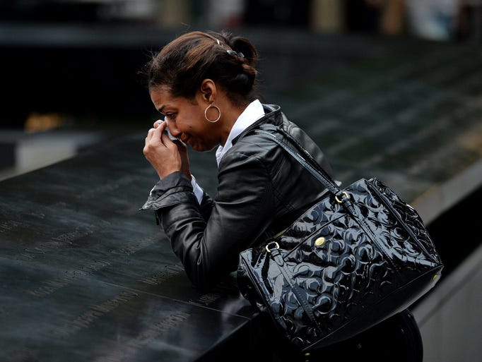 A woman visits the North Tower Memorial Pool at the World Trade Center site in New York.