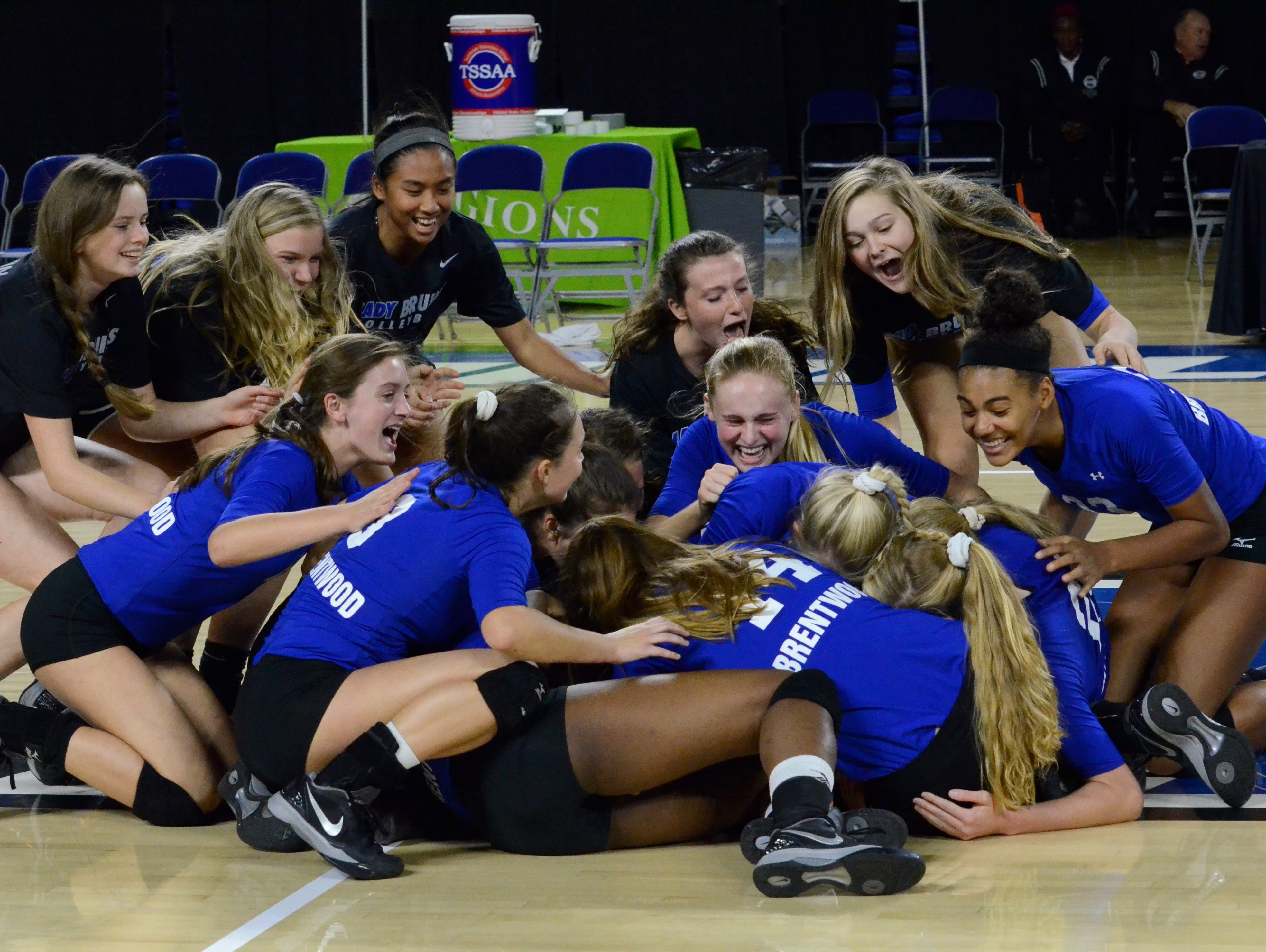 The Lady Bruins celebrate at center court after defeating Farragut 3-0 in Friday's Class AAA title match.