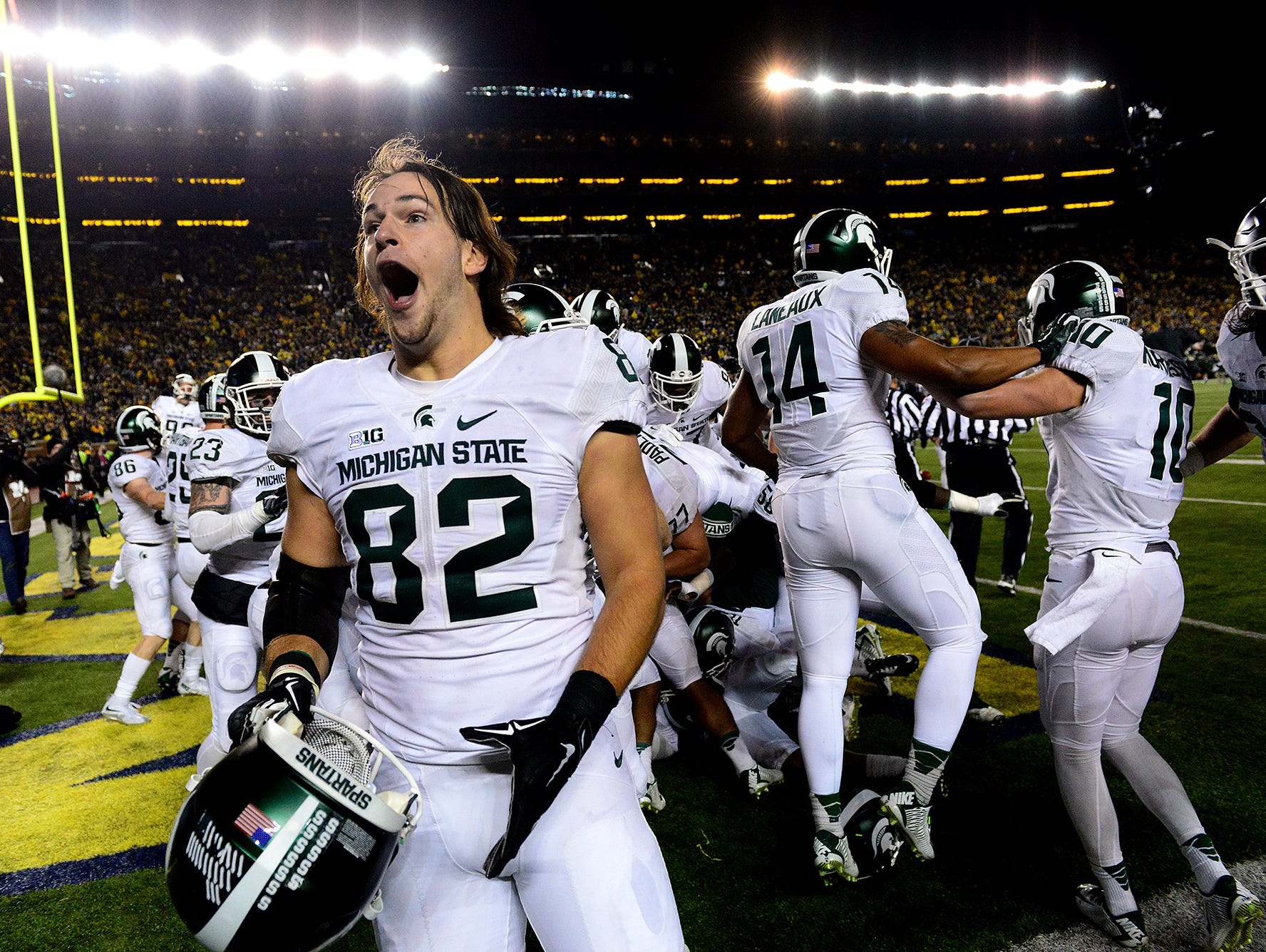Michigan State tight end Josiah Price screams as he celebrates with teammates after a thrilling, last-second 27-23 victory over Michigan Saturday in Ann Arbor.