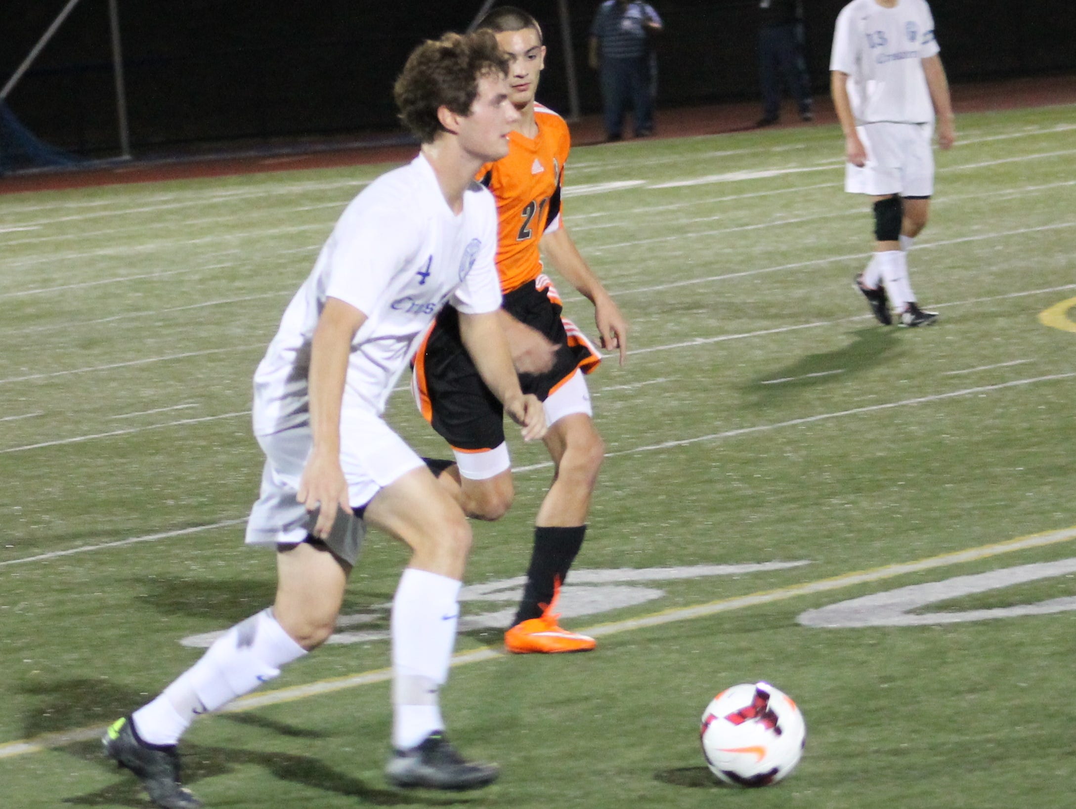 Senior Charles Chuey brings the ball up for Moeller with Beavercreek's Dominic Calabrese in pursuit.