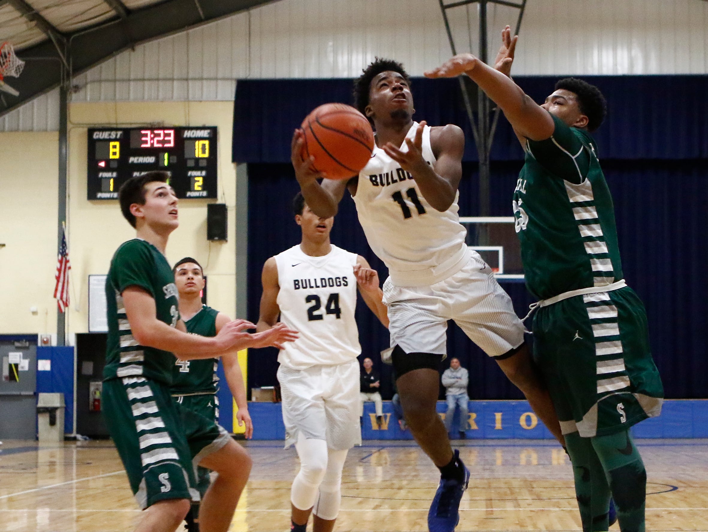 Beacon's Zamere McKenzie (11) drives on Spackenkill's Kyiev Bennermon (25) in the championship game of the Duane Davis memorial basketball tournament at Our Lady of Lourdes High School in Poughkeepsie on Saturday, December 31, 2016.