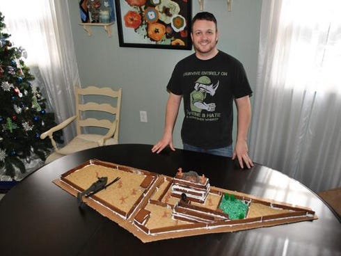 Steve, an Army military intelligence officer,  displays his gingerbread house model of Osama bin Laden's compound.
