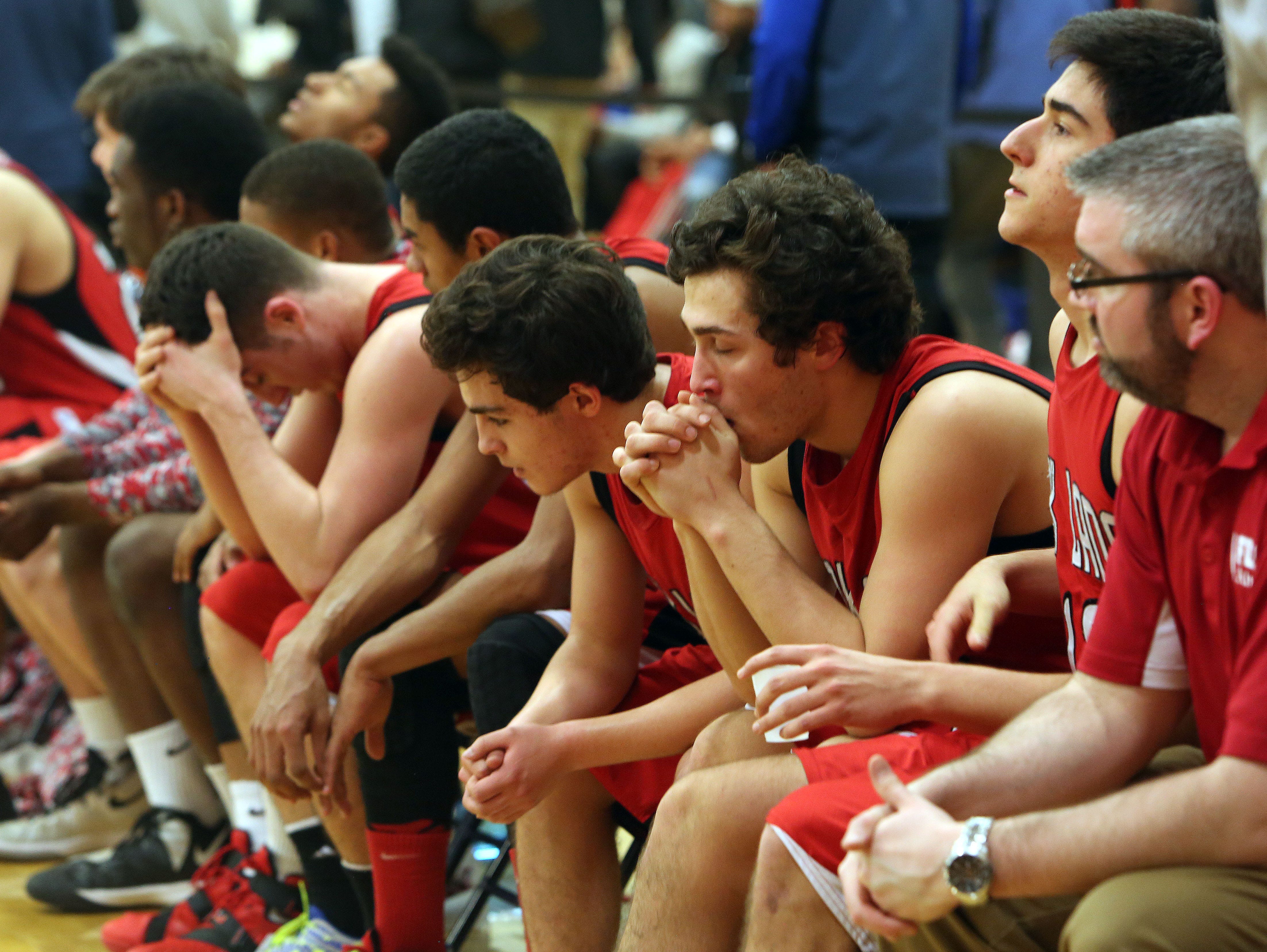 Fox Lane players watch from the bench as their season ends in a 62-44 loss to Middletown during the boys basketball Class AA regional finals at Orange Community College in Middletown March 4, 2016.