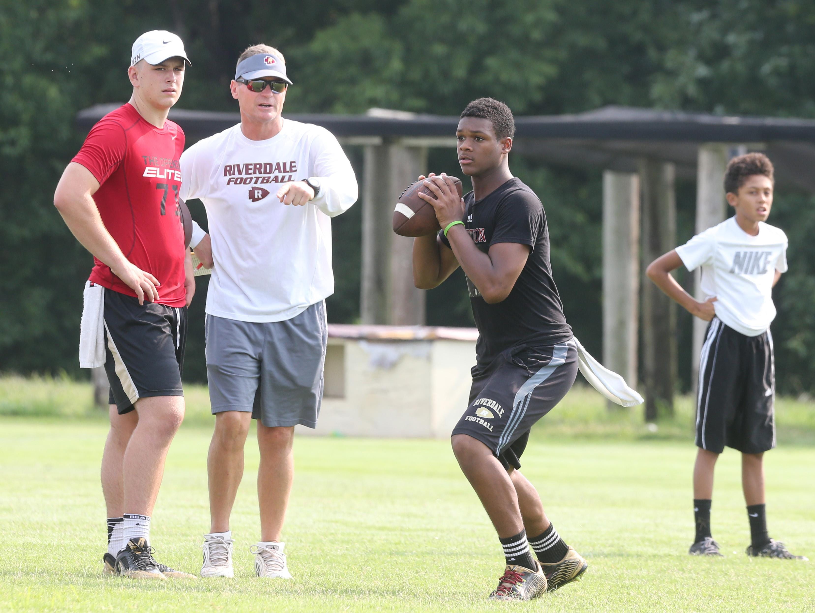 Christian Souffront looks to make a pass at Brandon Bea, left, and Riverdale coach Ron Aydelott watch.