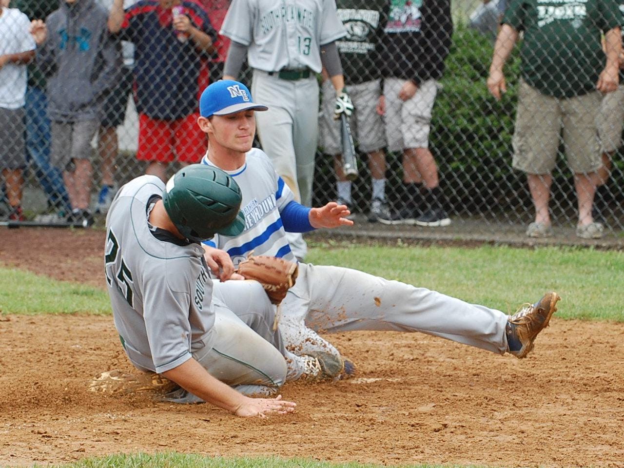 Nick Polizzano of South Plainfield is safe at the plate as Northern Burlington pitcher Ryan Shinn applies a late tag in the fifth inning Saturday.