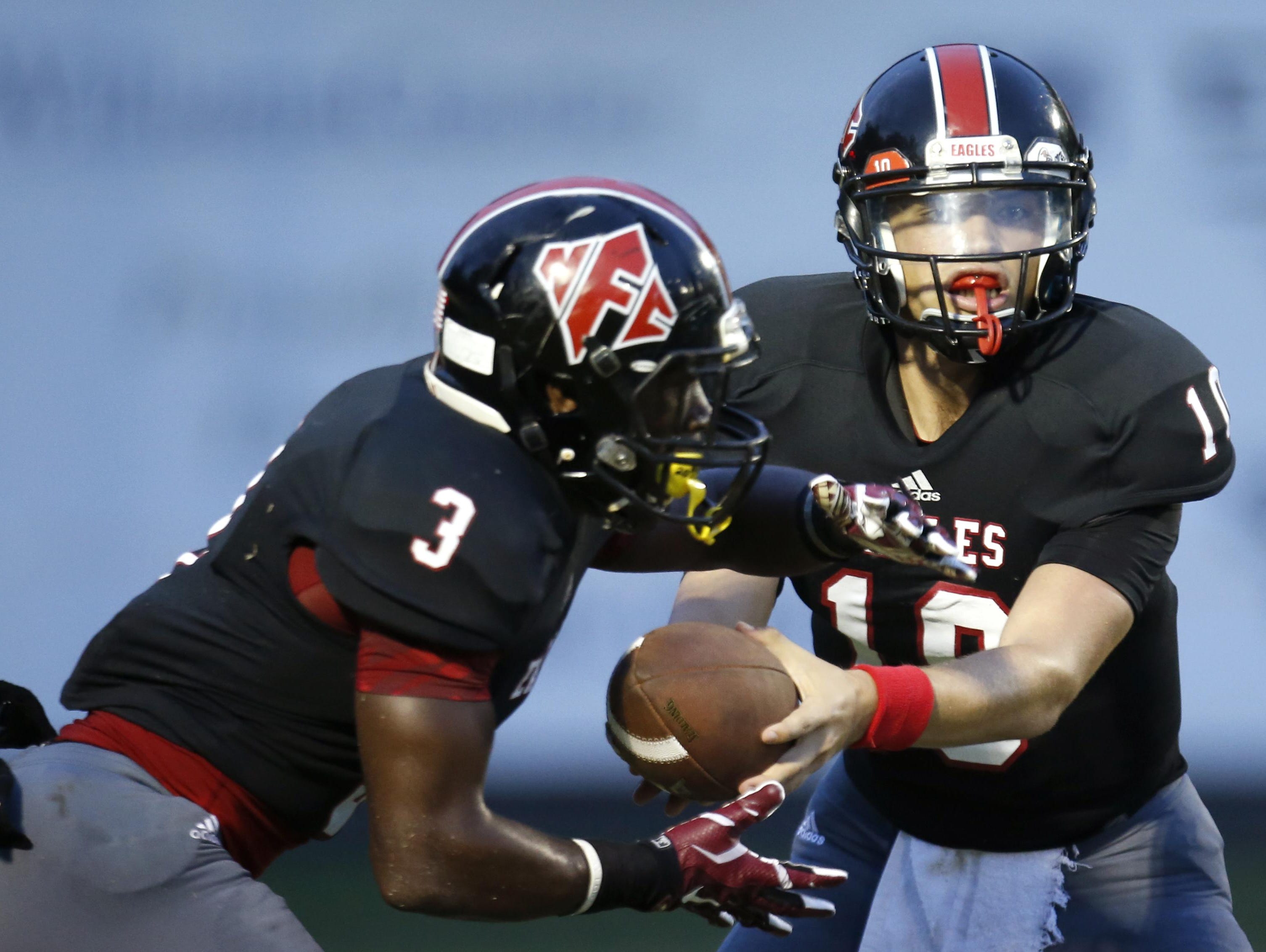 NFC quarterback Avery Thomas hands the ball off to Terrell Powell for the carry against Chiles during their game at North Florida Christian.